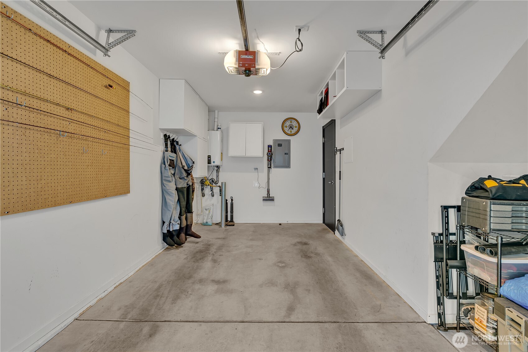 Spacious 1 car garage with extra storage and tankless water heater.