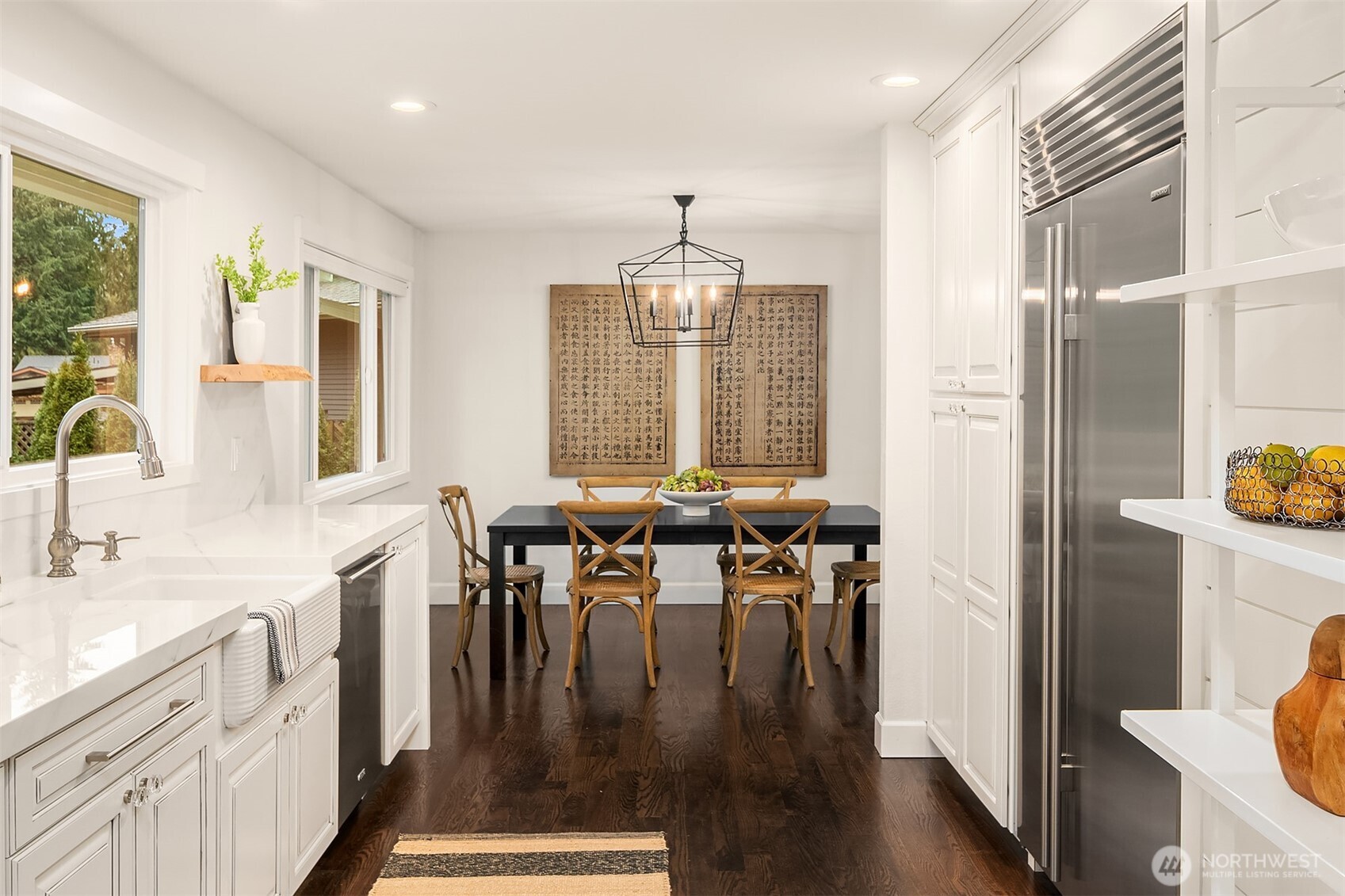 A different perspective from the eat-in kitchen area. Light and bright with picture window views of the surrounding flora.