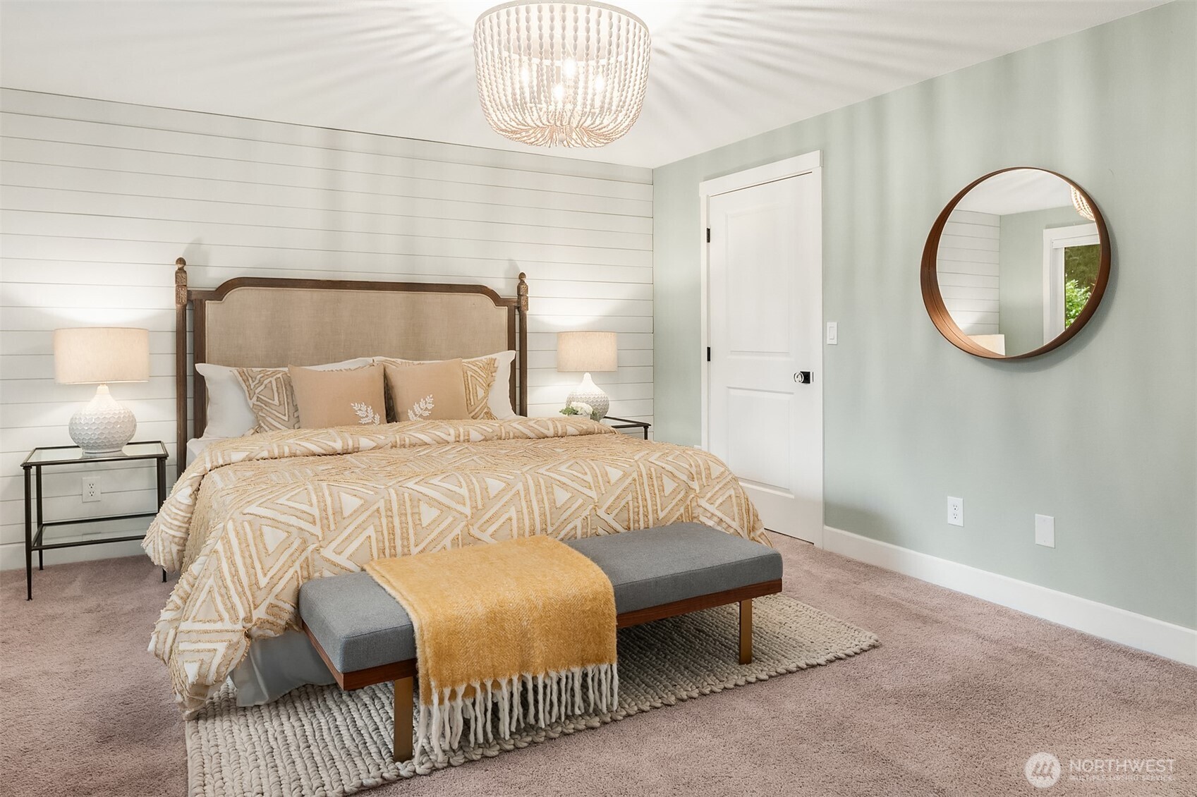 The gleaming interiors of this primary ensuite are very complimentary of the beautiful primary bedroom. This space features a double vanity with full-length mirror and step-in shower with handheld fixtures. Don't miss the brilliant seated vanity space seen here.