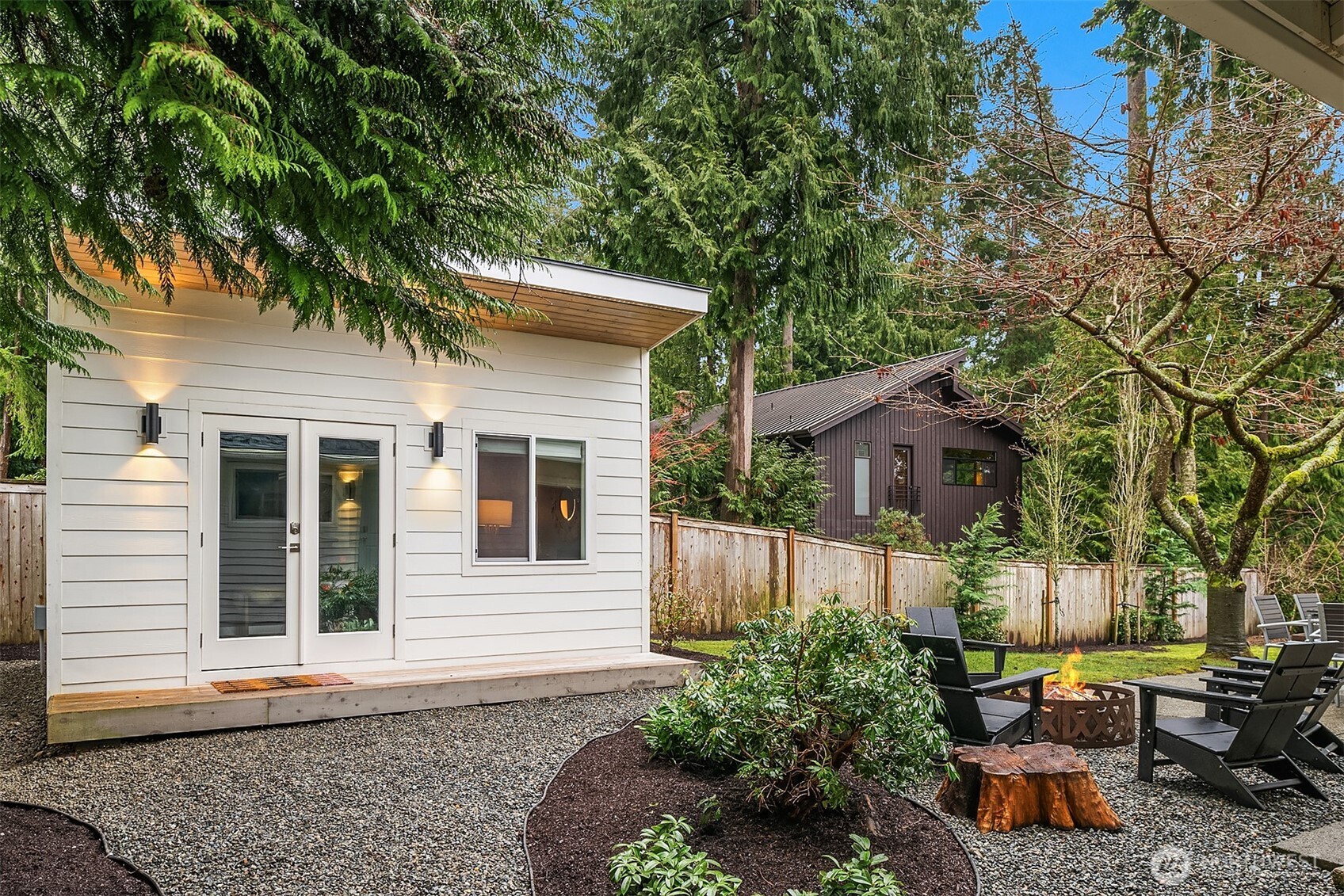 Pictured here is the detached studio interior with modern light fixture and handsome paint features. This space offers electricity and internet.