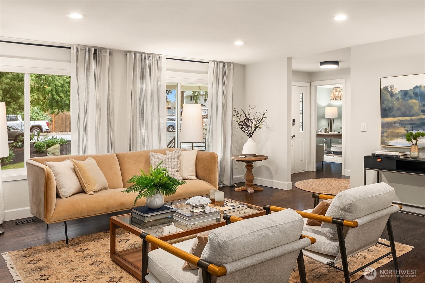 Another view of the living room looking towards the front entryway, and the versatile home office space beyond in the distance.