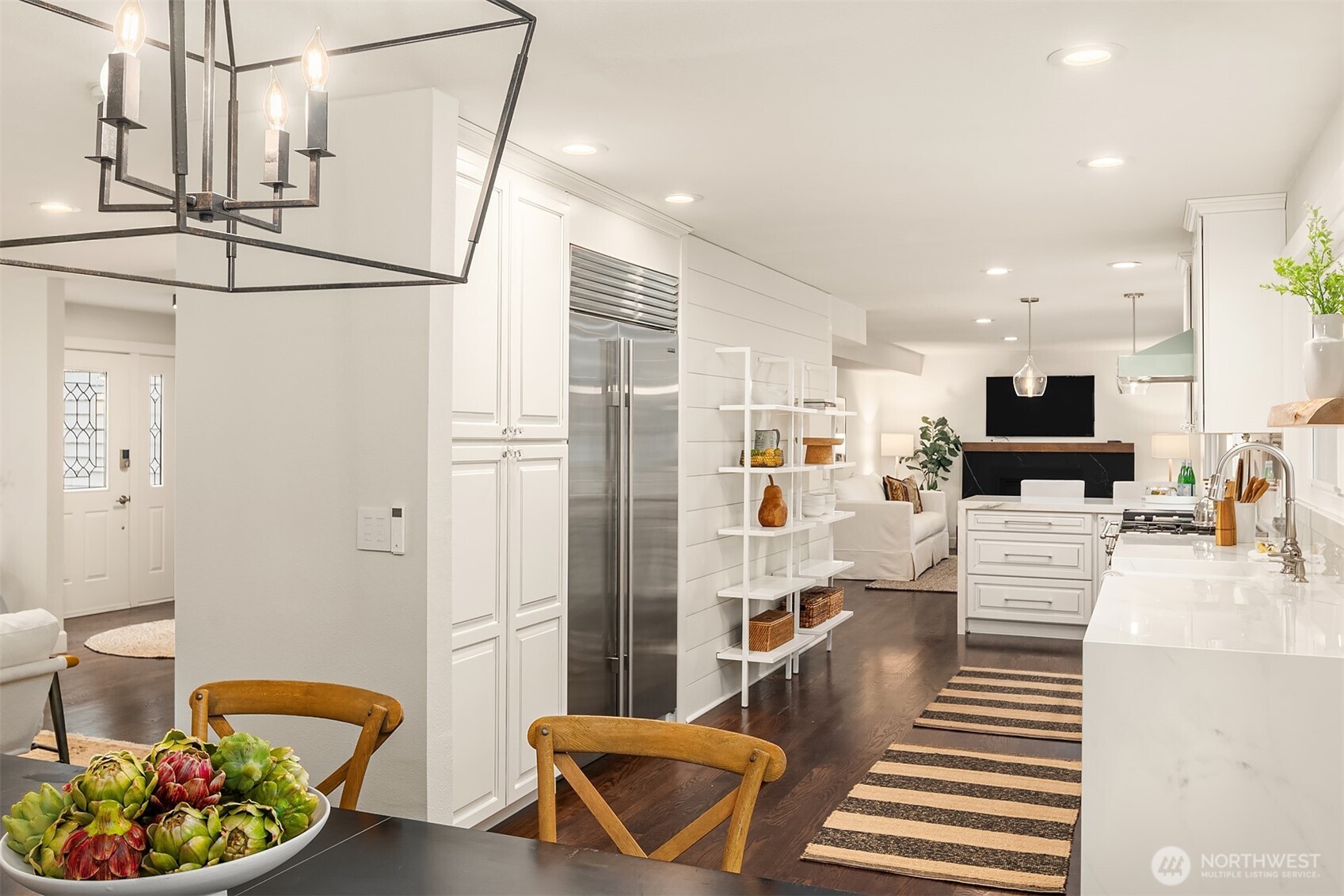 This stunning kitchen boasts sleek soft-close cabinets with sparkling countertops and stainless appliances.