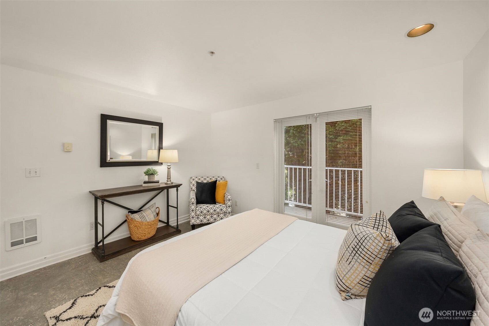 Owners bedroom with modern concrete flooring, new Milgard French Doors.