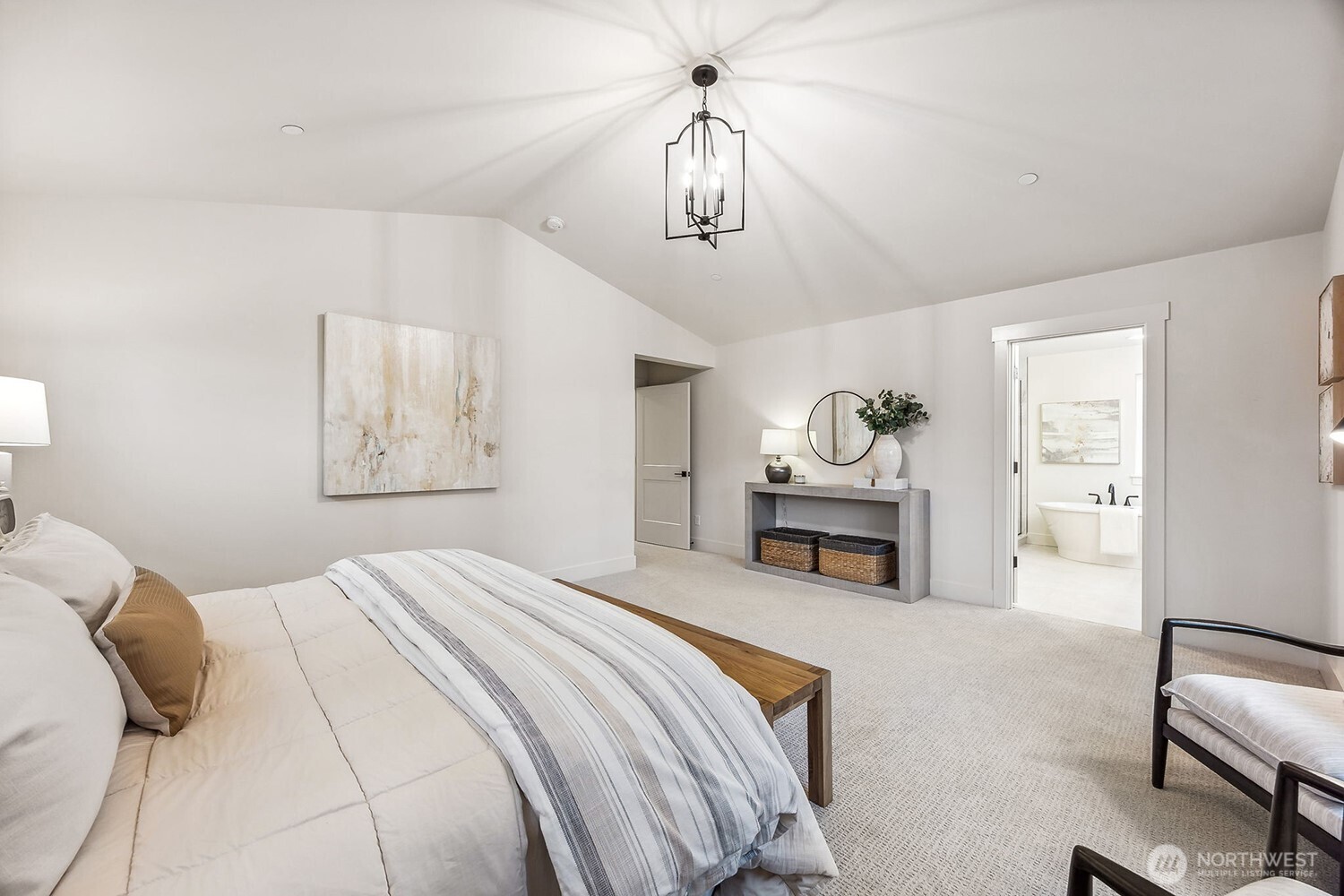 Elegant primary suite with vaulted ceilings and expansive windows. Photos are of the Magnolia model home at Maywood Heights on lot 8. Photos are for illustration purposes only; colors and finishes will vary.