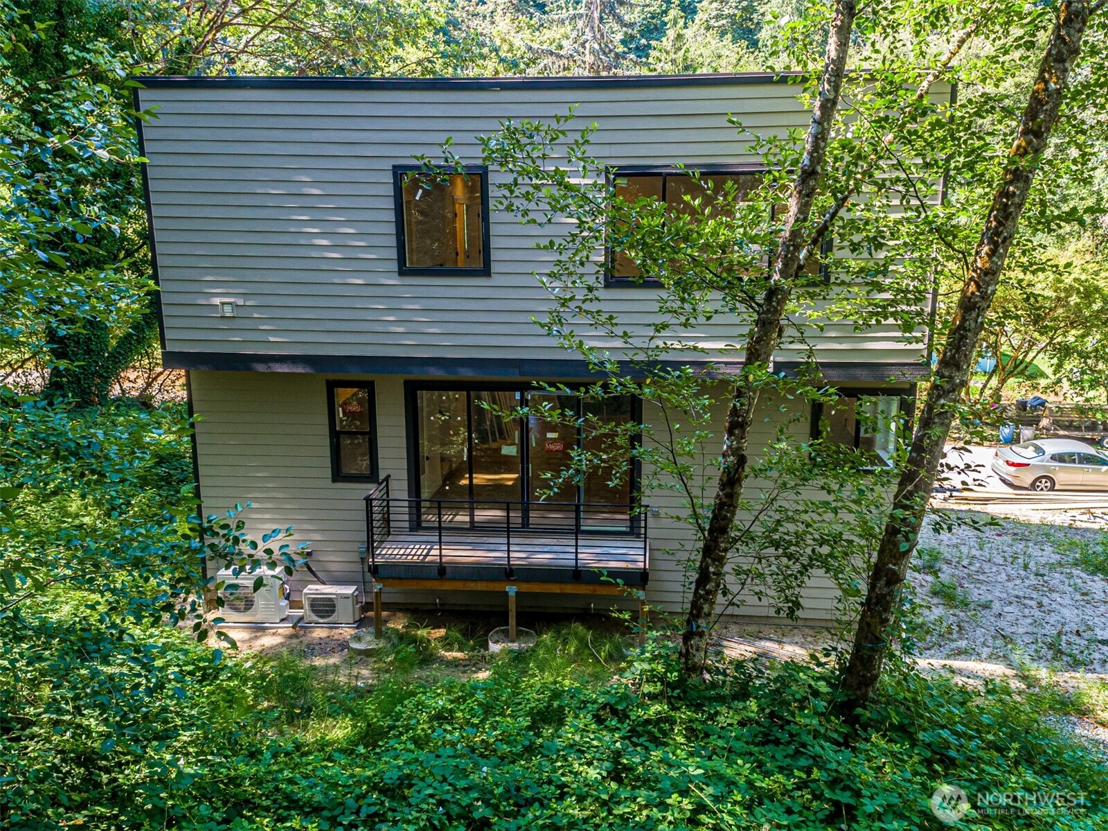 Living space with doors to the front deck looking out to Coal Creek