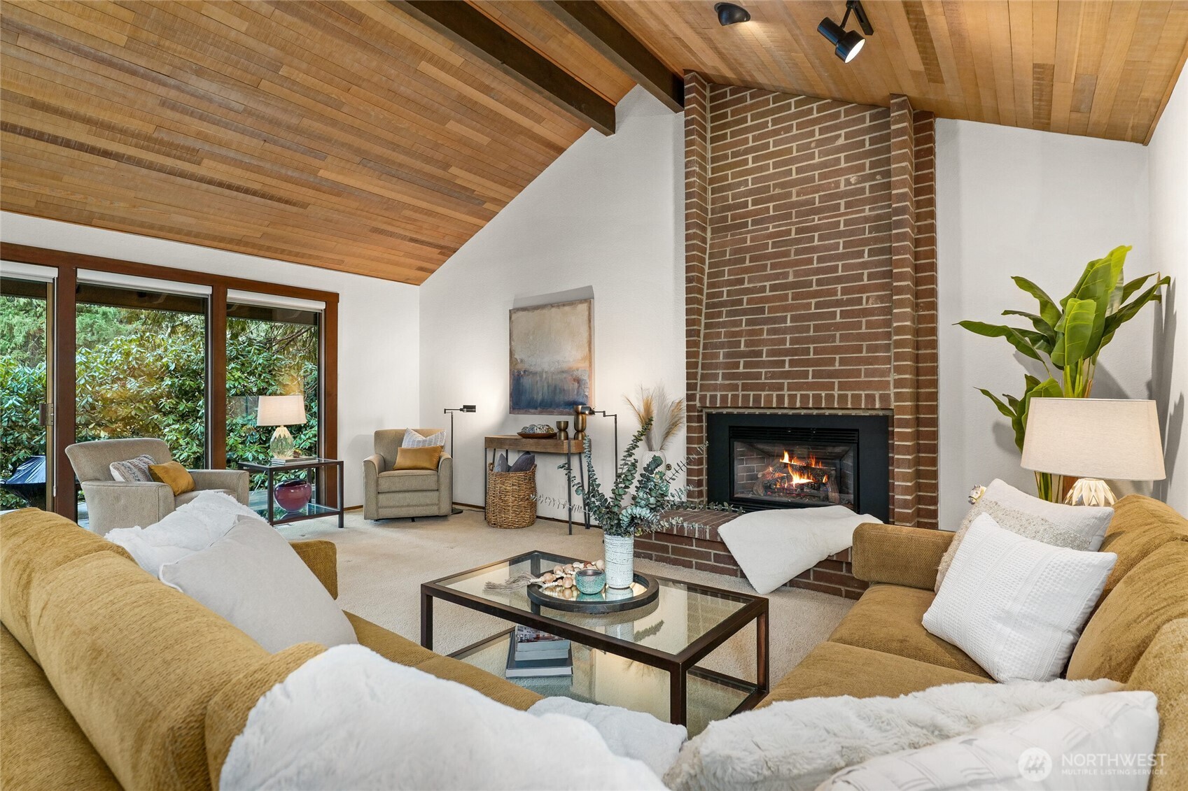 Vaulted ceilings, gas fireplace and banks of windows, with slider access to deck.