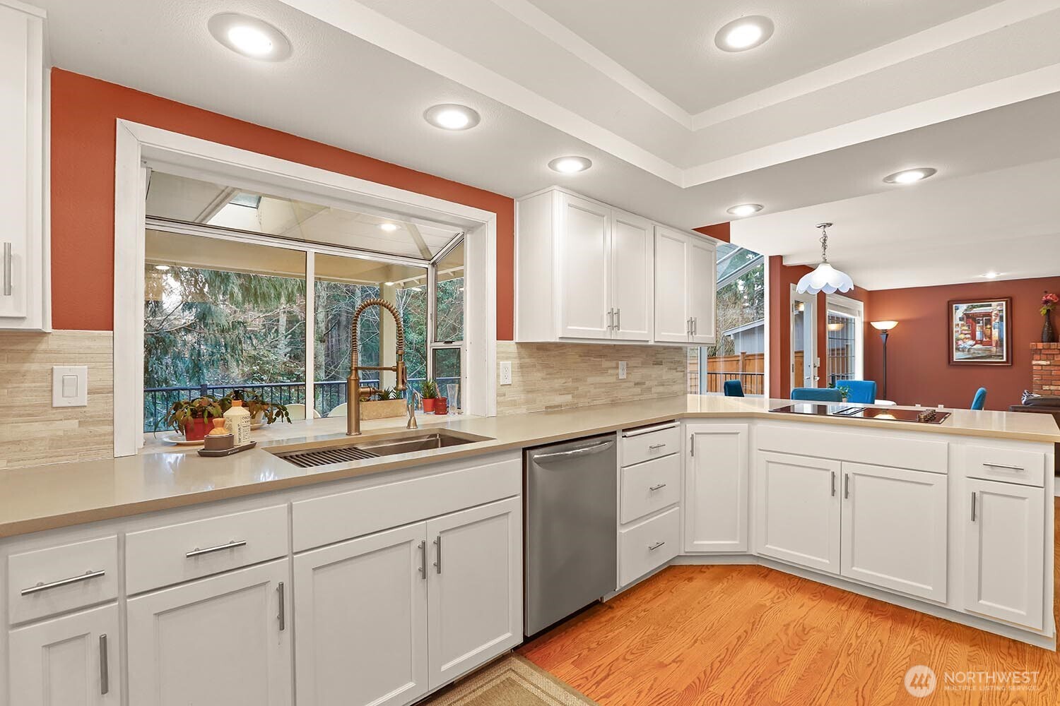 Newly updated kitchen with quartz counters, tile backsplash, and stainless appliances.