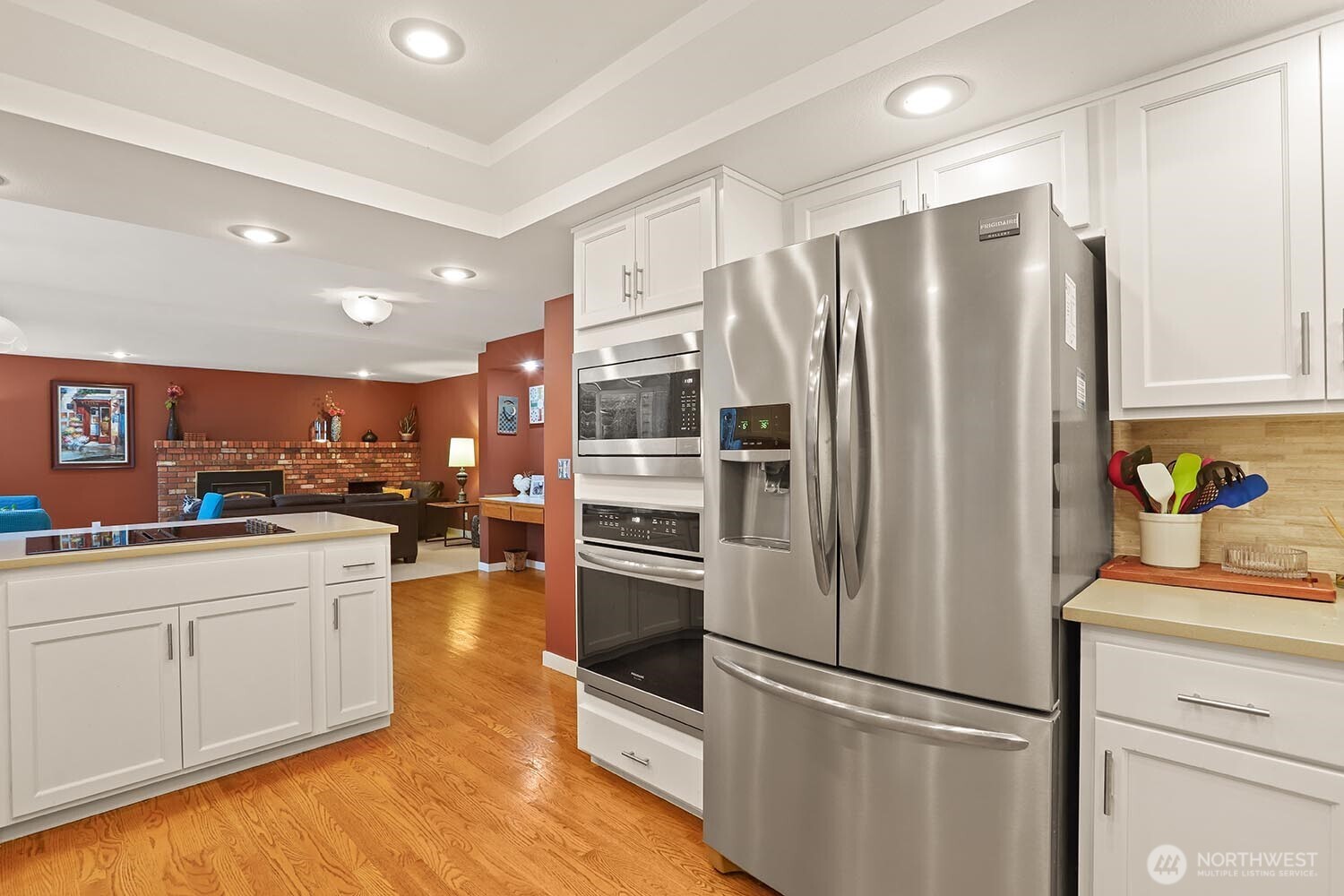 Newly updated kitchen with quartz counters, tile backsplash, and stainless appliances.