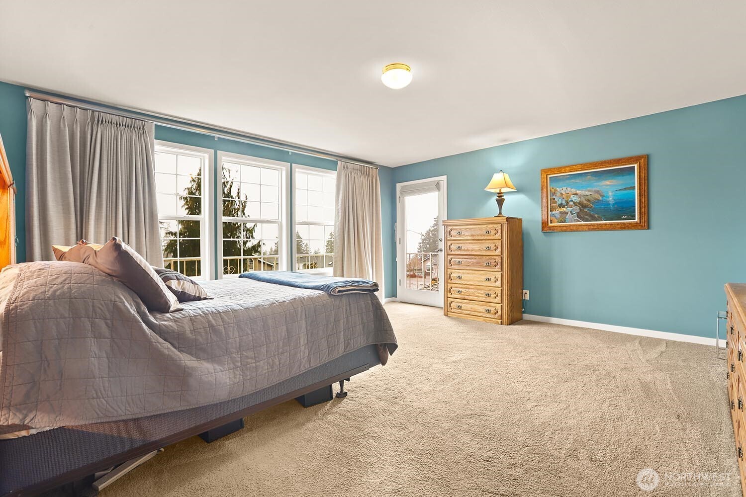 Primary bedroom with private deck overlooking Puget Sound and Olympic Mountains.