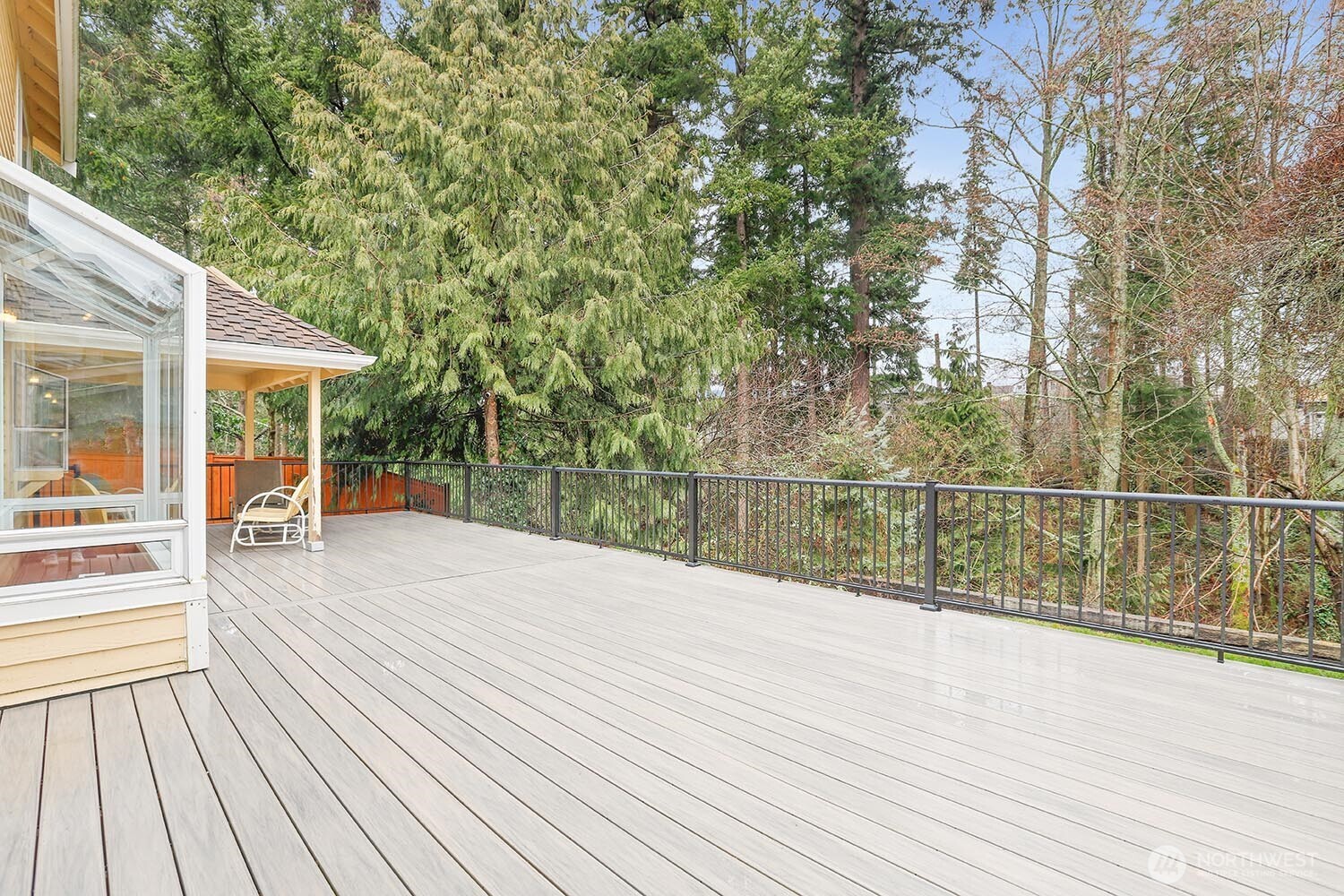 New composite deck overlooking tranquil greenbelt beyond.