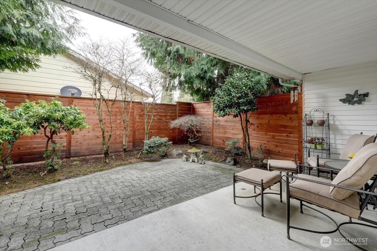 Private fenced back yard with covered patio. Note the newer fencing and stain.