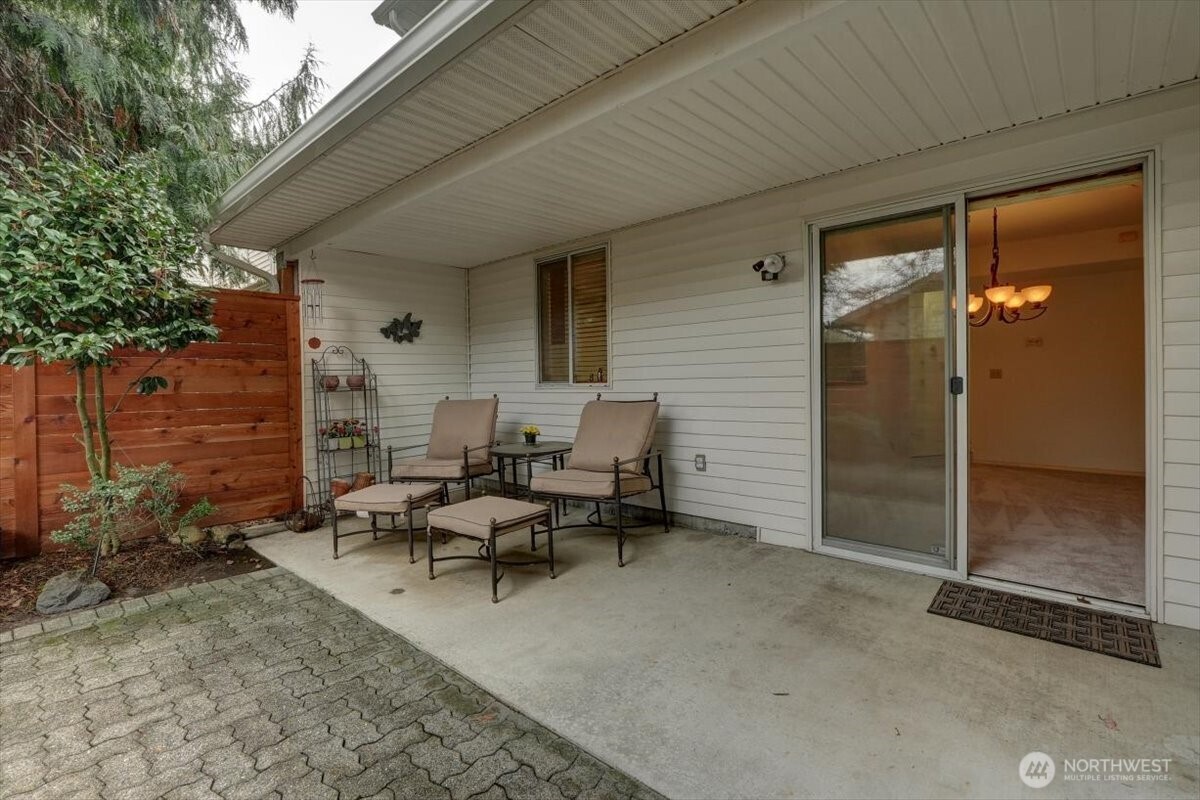 Covered back patio in fully fenced back yard. Patio furniture will convey.