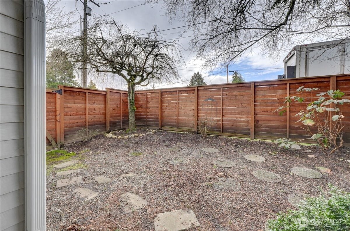 Side yard with gate to the left out to the driveway.