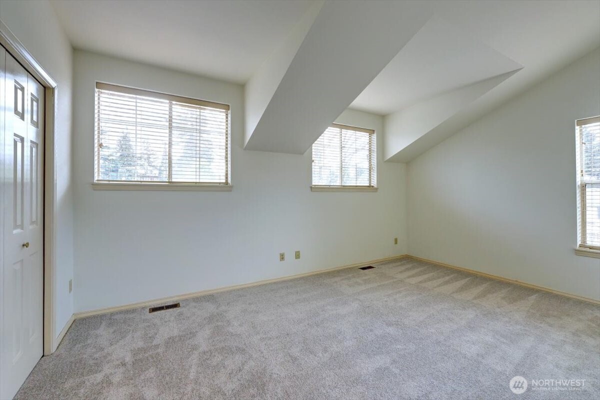 Primary bedroom is flooded with natural light.