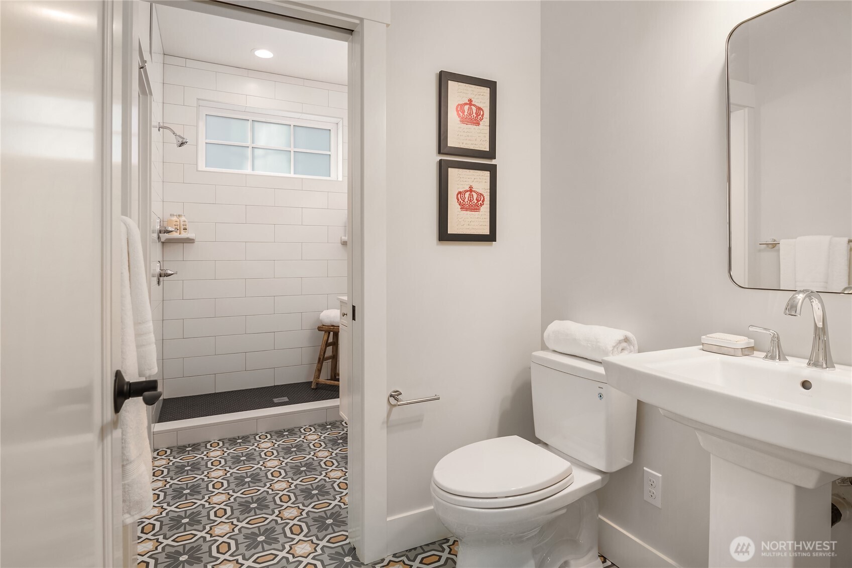 The main floor heated tile bath with pocket door separates the large shower with pedestal and 1.28 gallon Toto toilet.