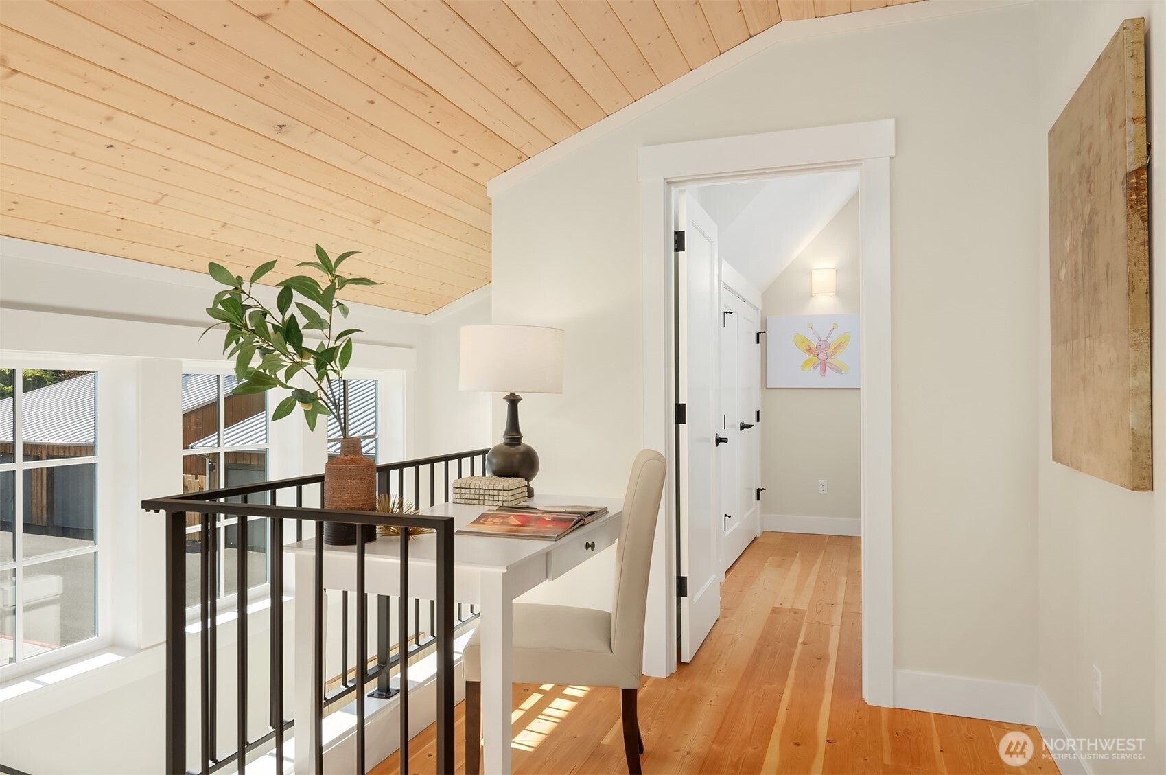 Explore the upstairs spaces and find a custom work space at the top of the stair landing. Solid wood flooring graces the upstairs bedroom spaces.