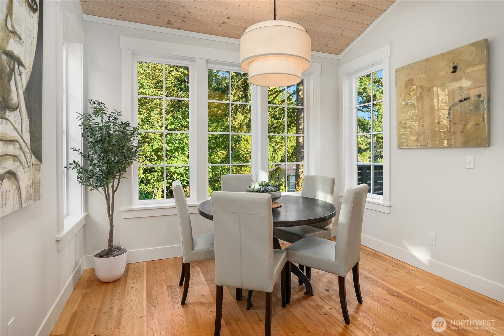 The generous dining room space overlooks the peaceful permanently preserved open space beyond.