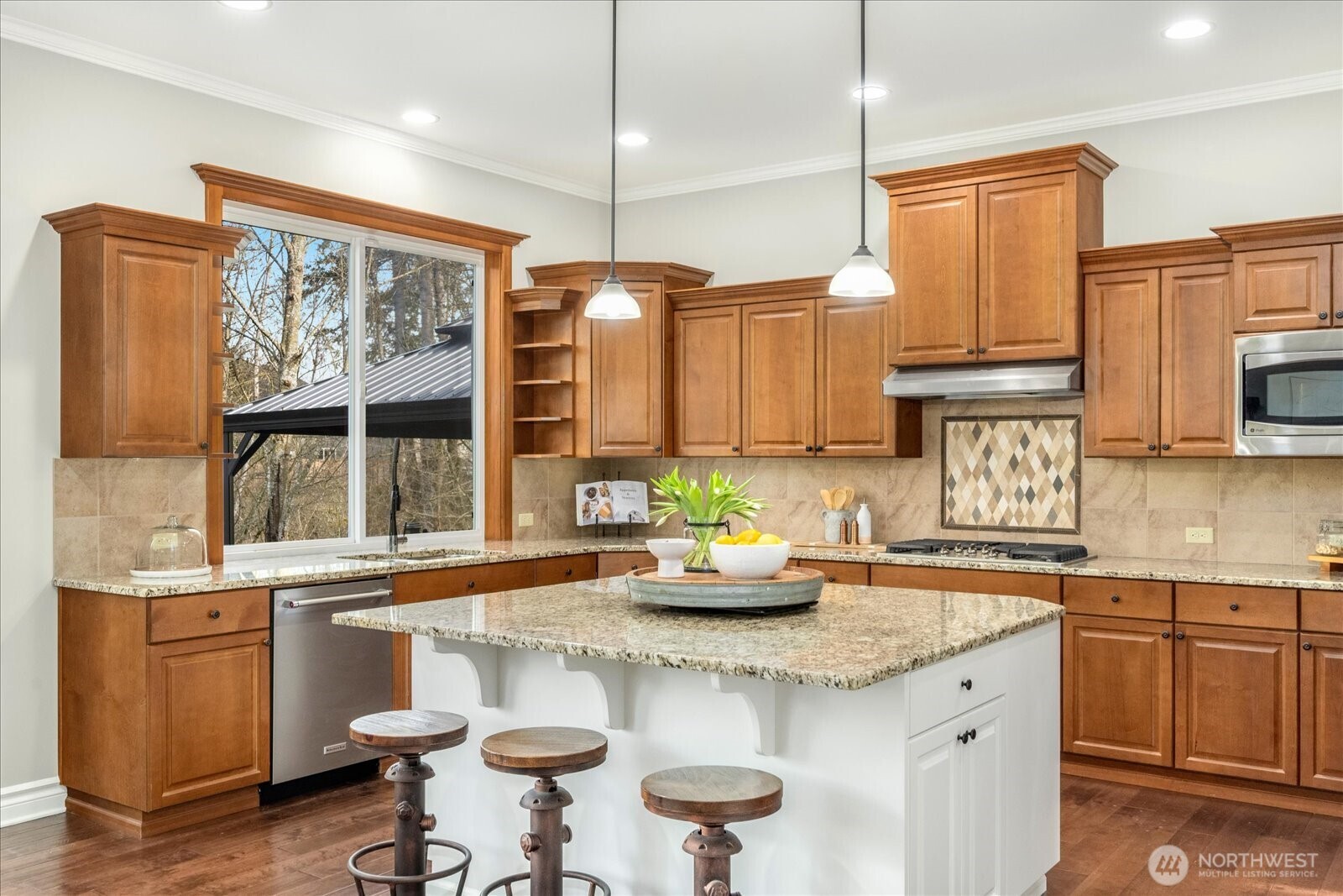 Chef's kitchen with gorgeous view overlooking private backyard