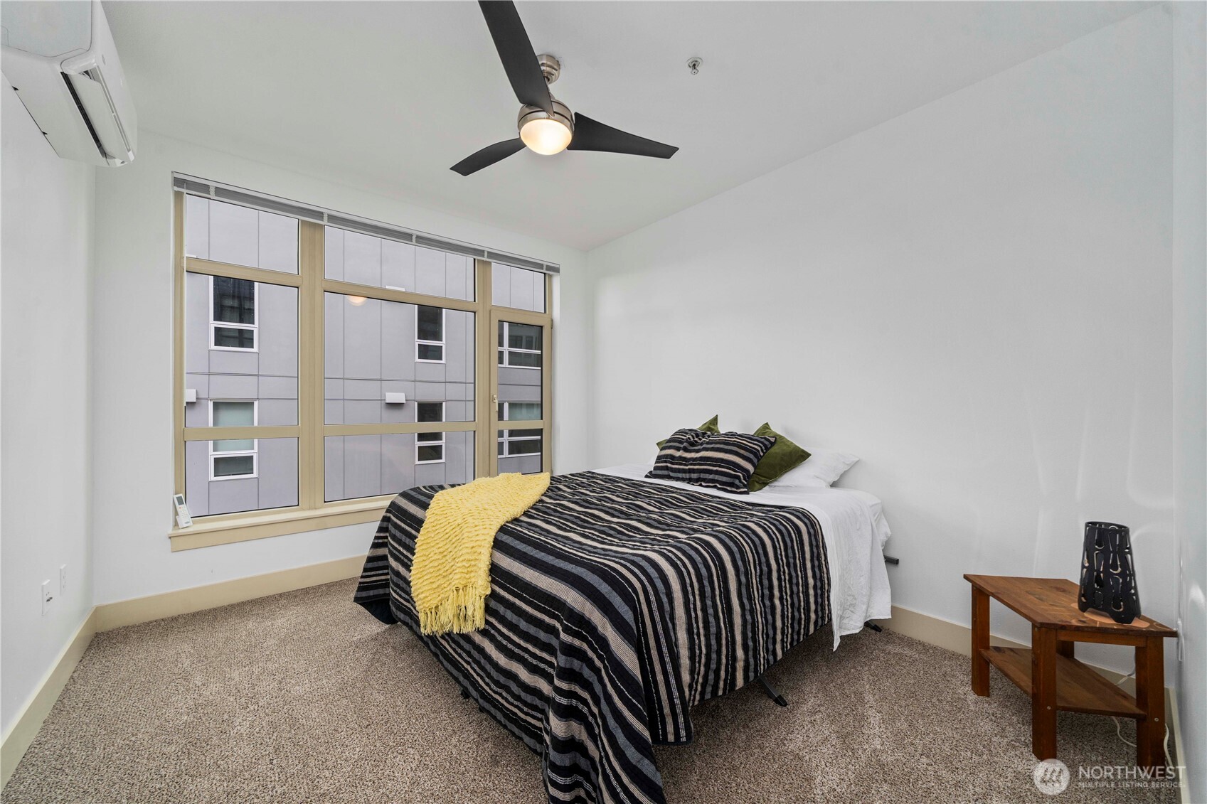 Primary bedroom suite with door that separates bath and closet from main living space