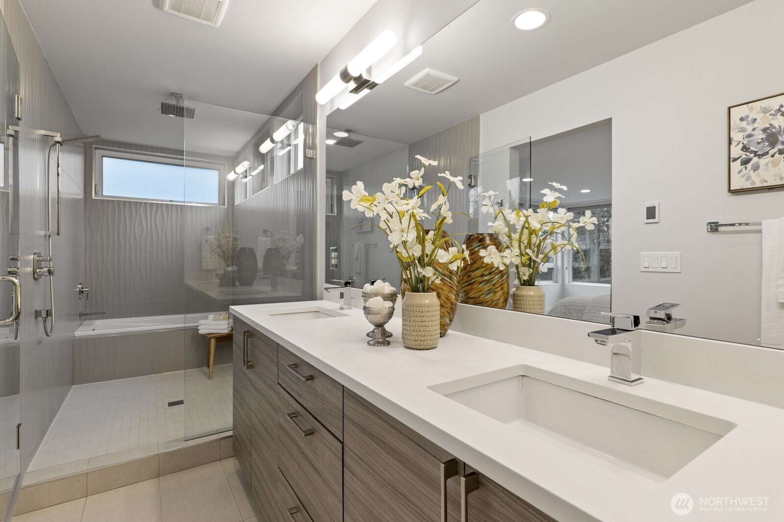 Primary bathroom with walk-in shower and tub, dual vanities, and heated floors.