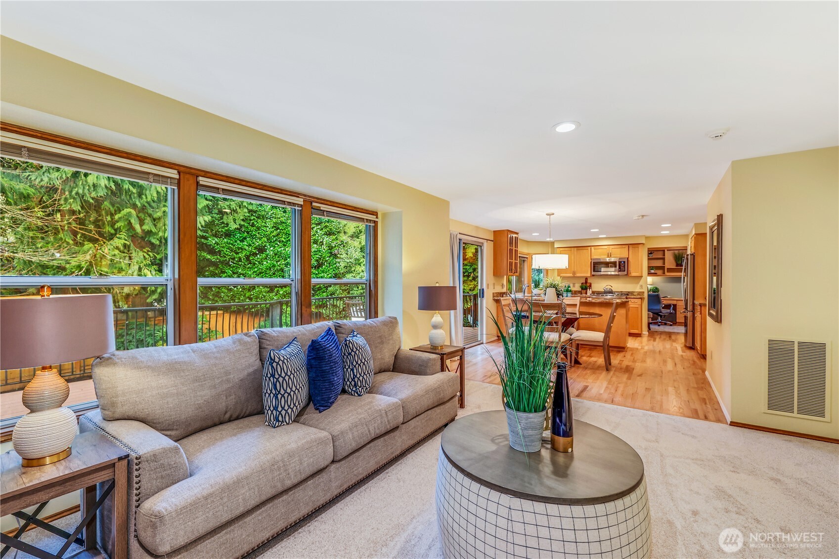 An open-concept design connects the family room, dining area, and kitchen, making it perfect for everyday living and entertaining. The newly installed carpet complements the refinished hardwood floors, creating a cohesive and inviting atmosphere.