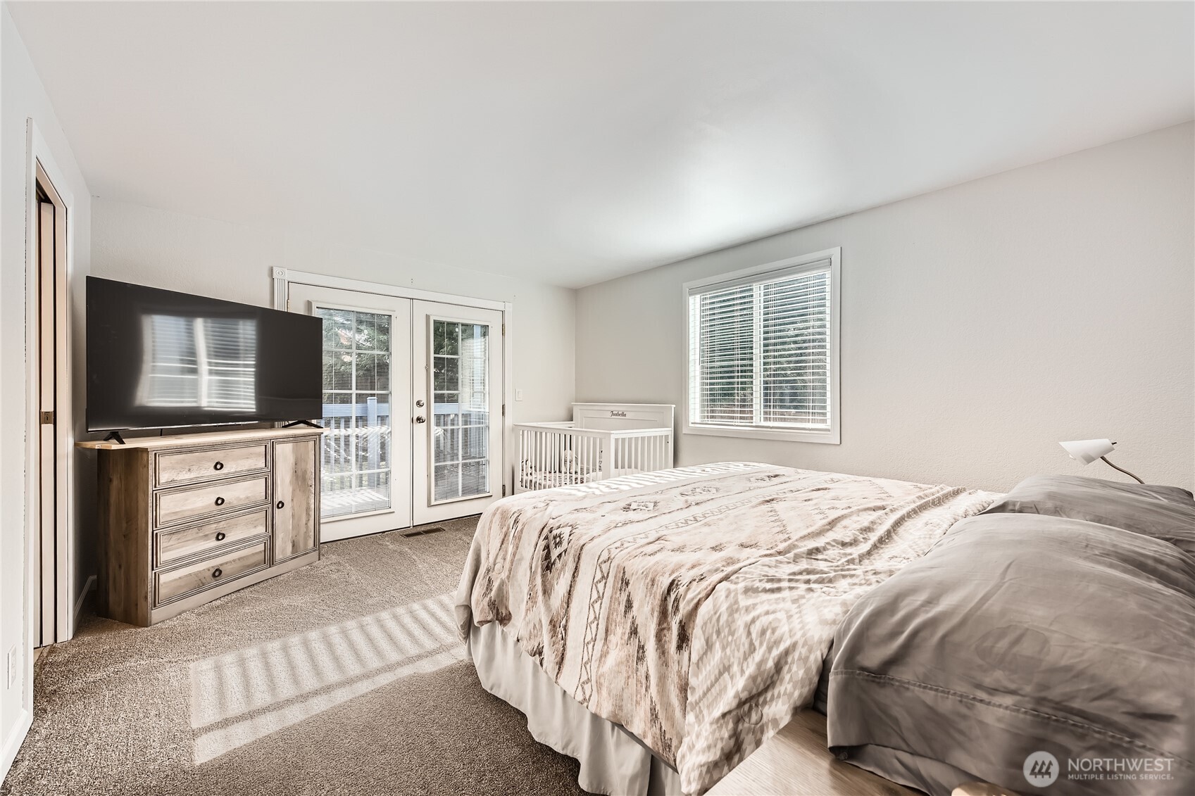 Primary bedroom with french doors to the deck...the sun just flows in