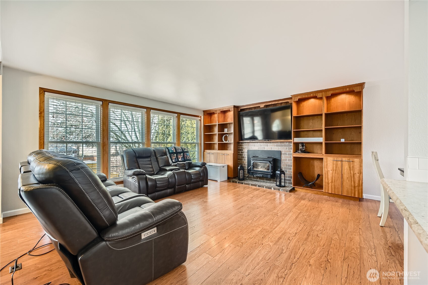 Light and bright living room with wood insert fireplace