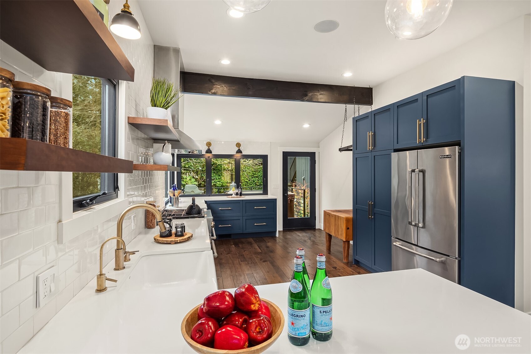 Everything about this kitchen is sublime! Sleek quartz counters, champaign bronze hardware,