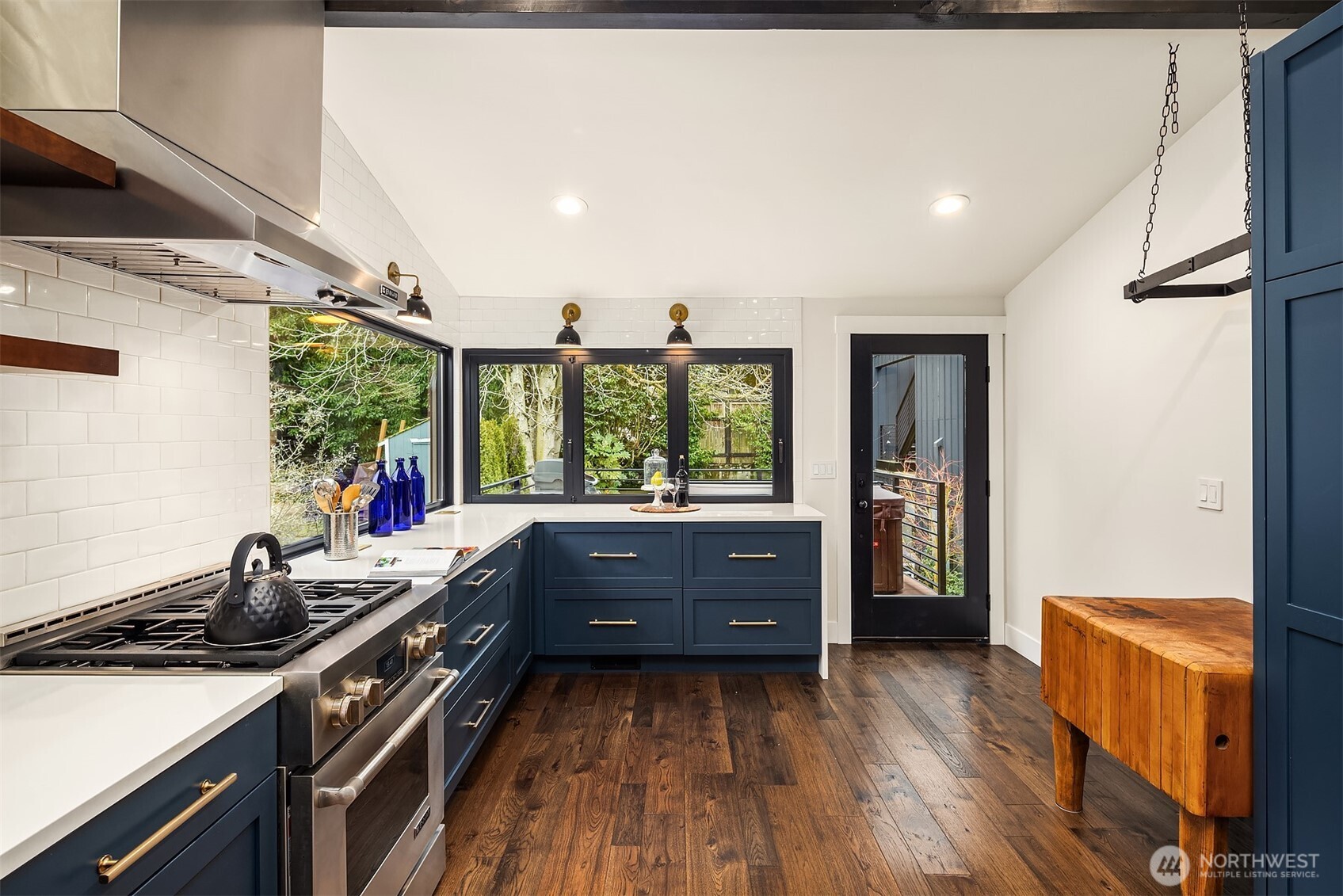 Included with this amazing kitchen is a hanging rack for pans and a nice, chunky butcher block table that could be moved and centered in the space to be used as a center island.