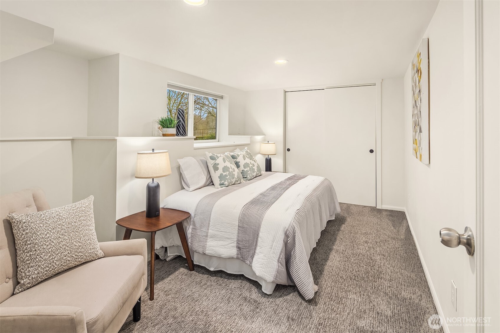 Bedroom 1 on the lower level boasts a big window floods the room with natural light.