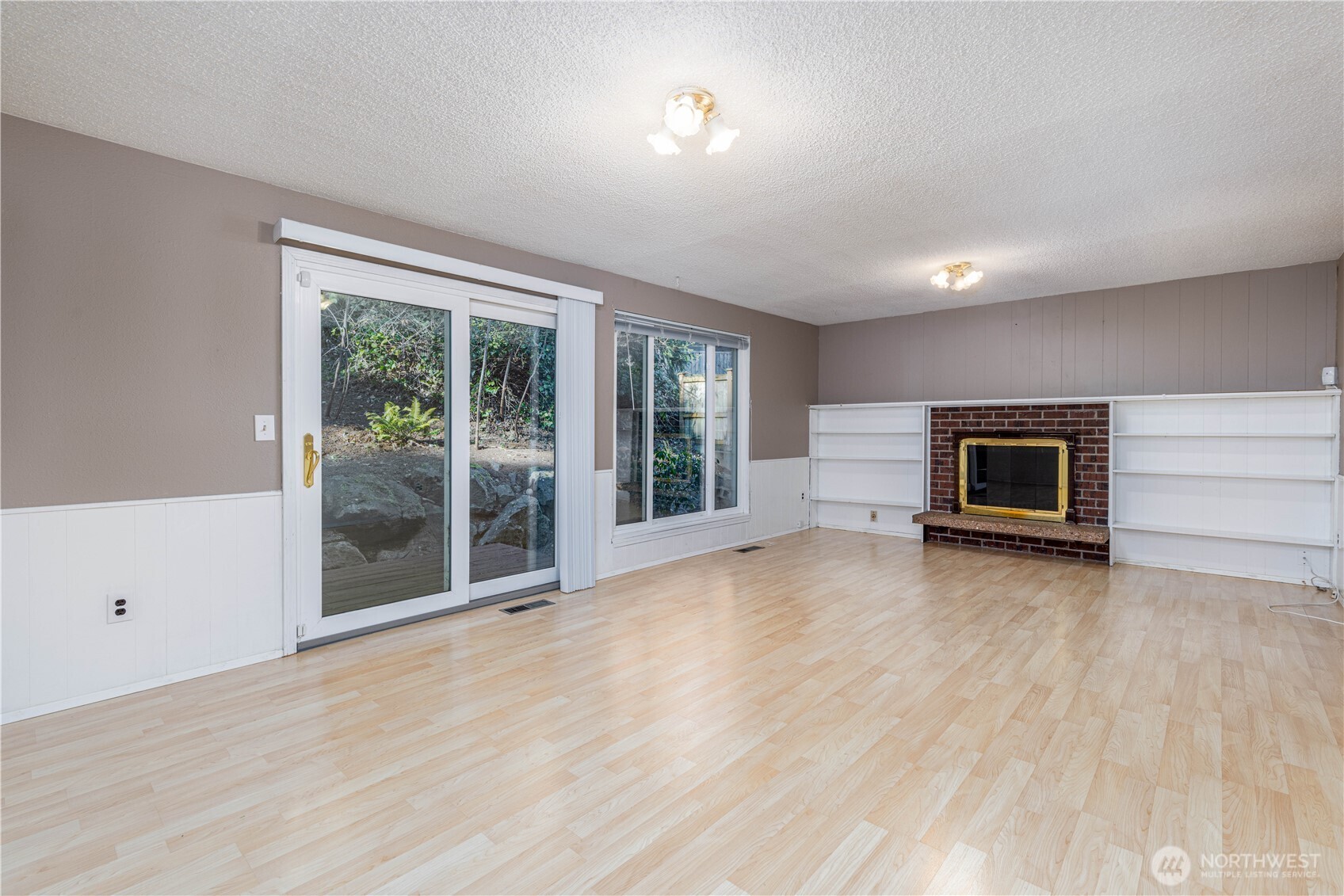 Cozy living room with built-ins and wood burning fireplace!