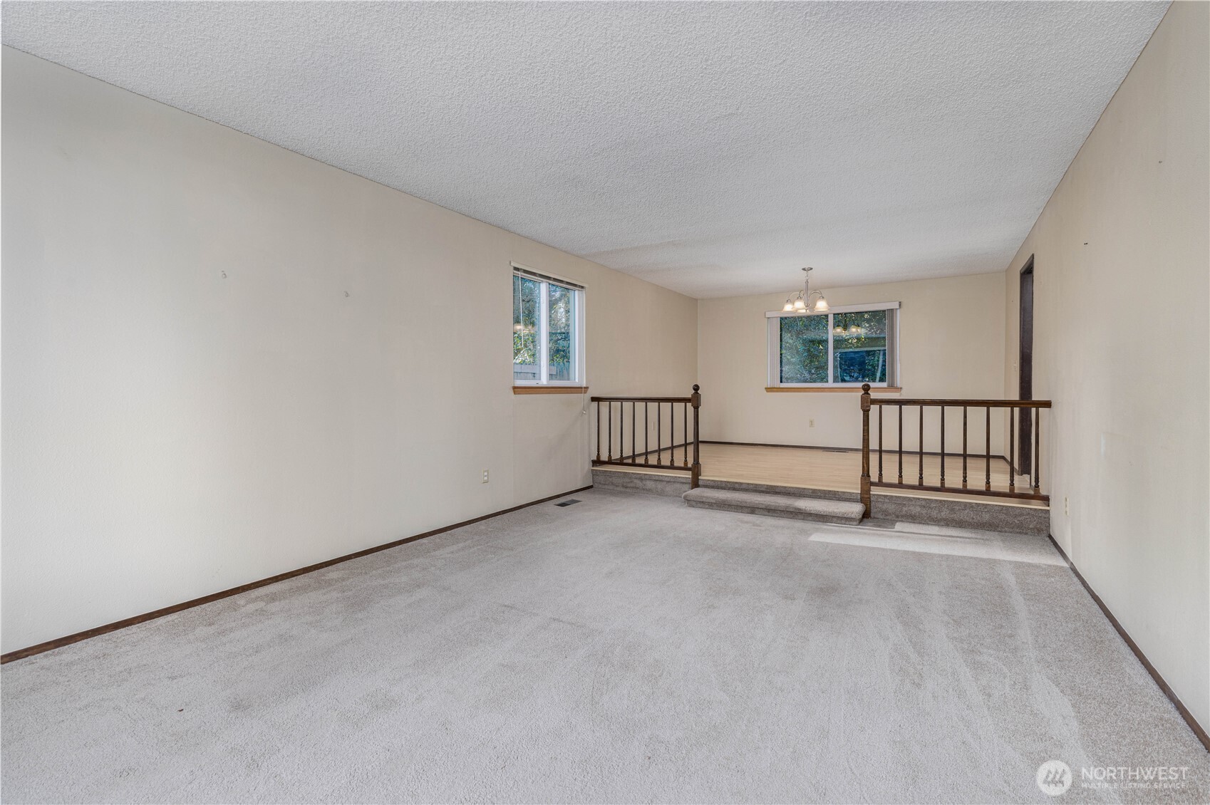 Carpeted family room leading to dining area.