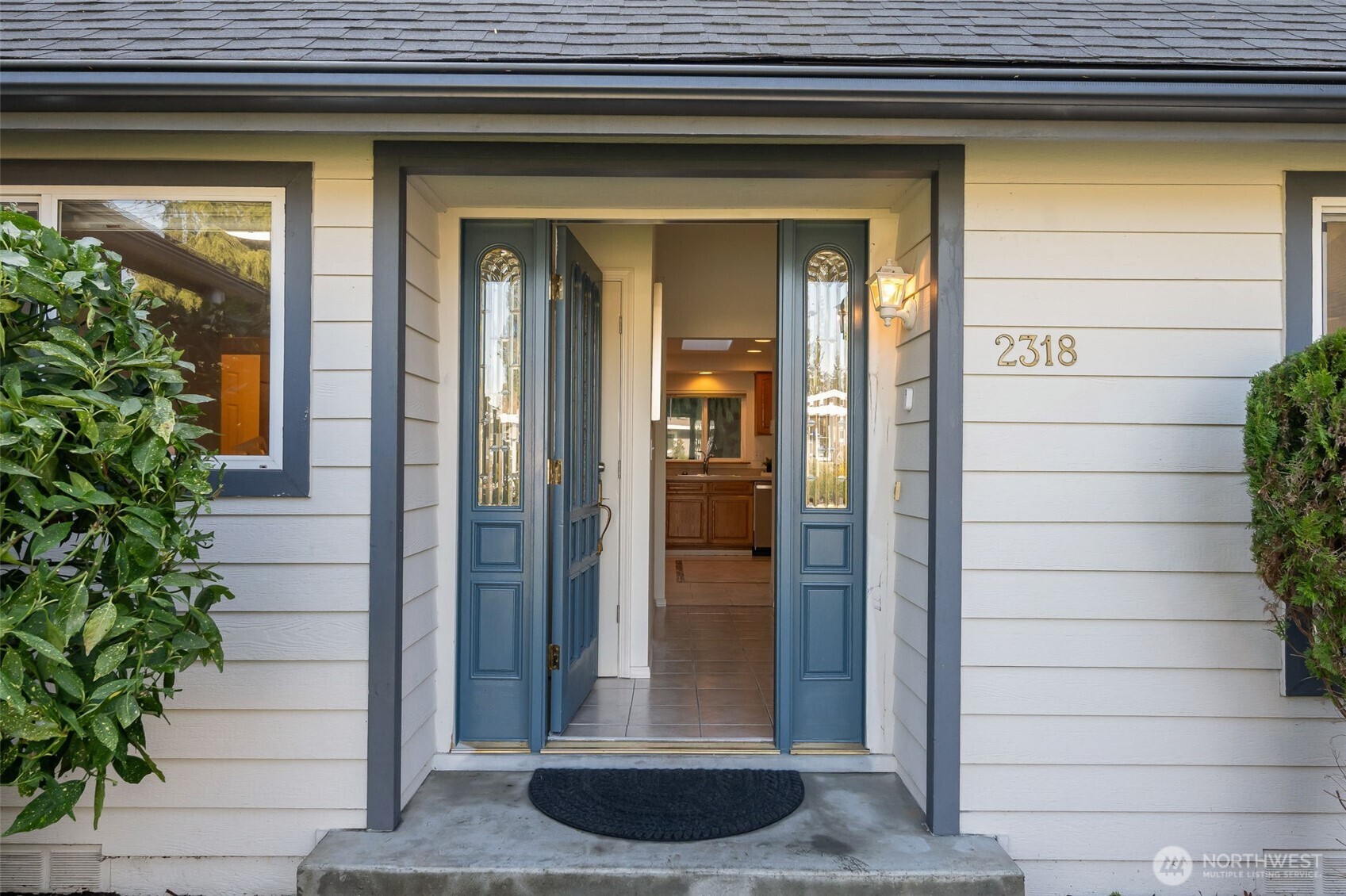 A newly painted front door ushers you inside.