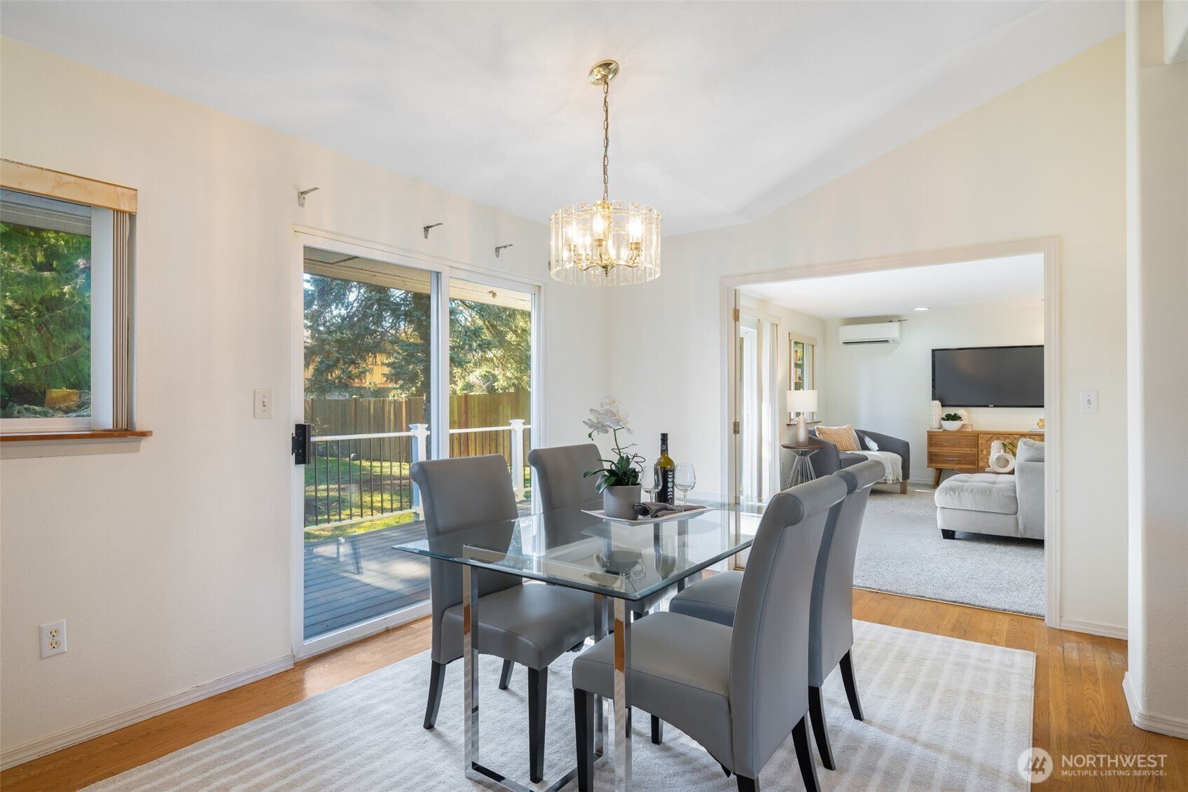 A dining room connects the living room, family room, and kitchen, with bright south facing sliding doors leading to the back deck and yard