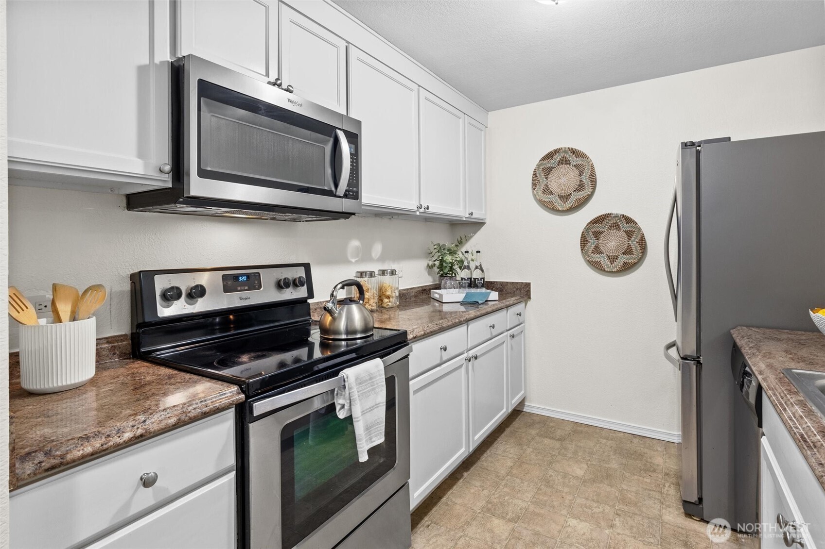 Sleek stainless steel appliances and ample storage.