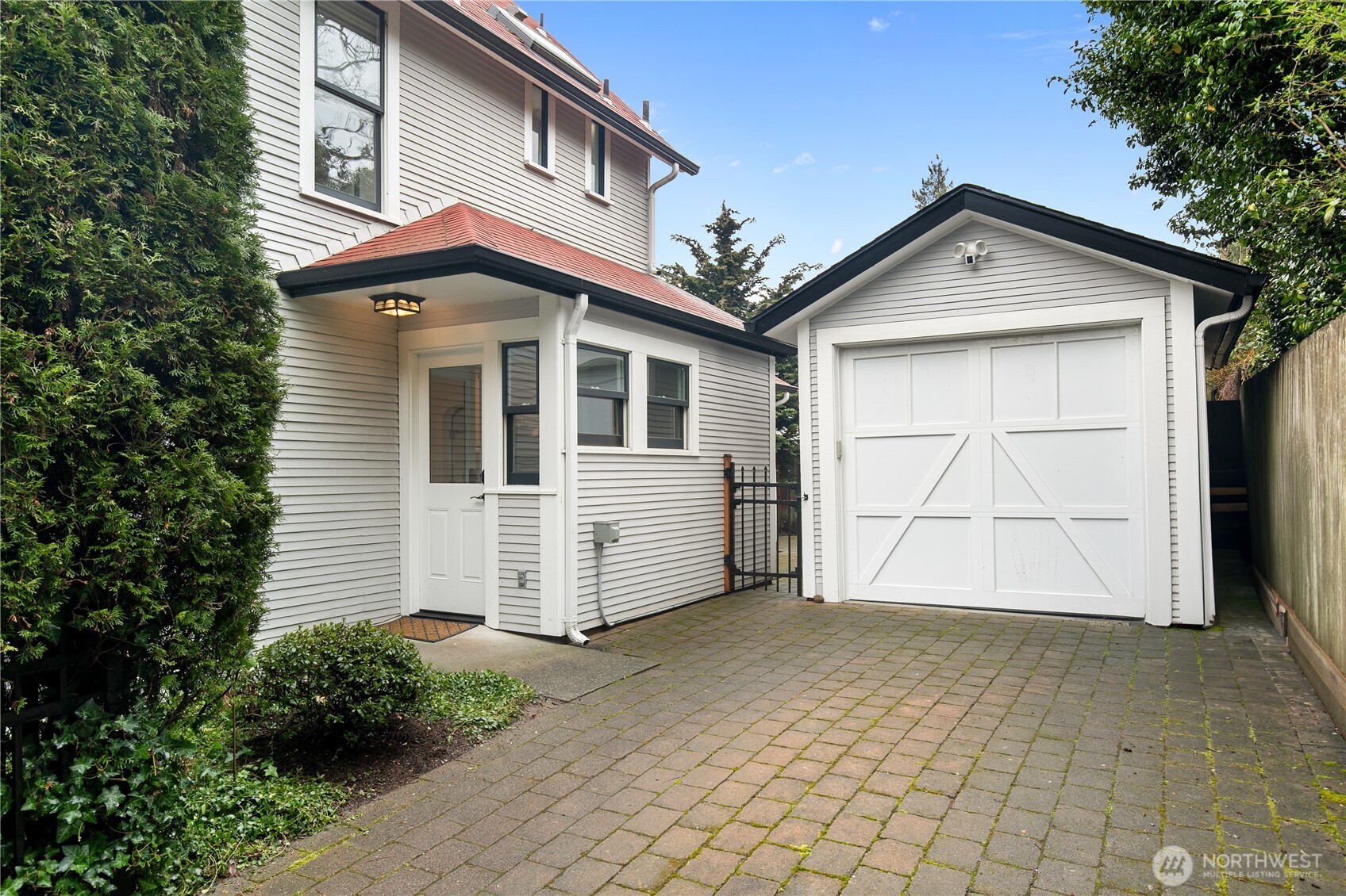 Detached garage plus 220 EV car charging in the driveway.