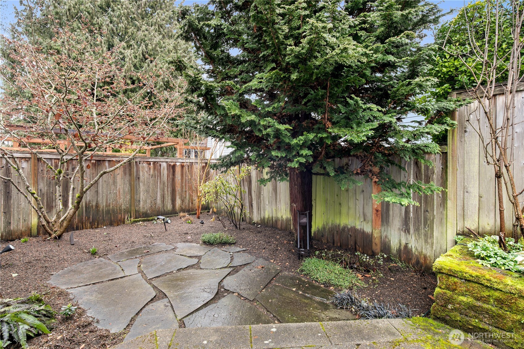 This peaceful corner of the yard feels like a private retreat, ideal for gardening enthusiasts or those seeking a quiet escape. Pride of ownership is evident in every carefully curated detail, reflecting the home’s superb maintenance and design.