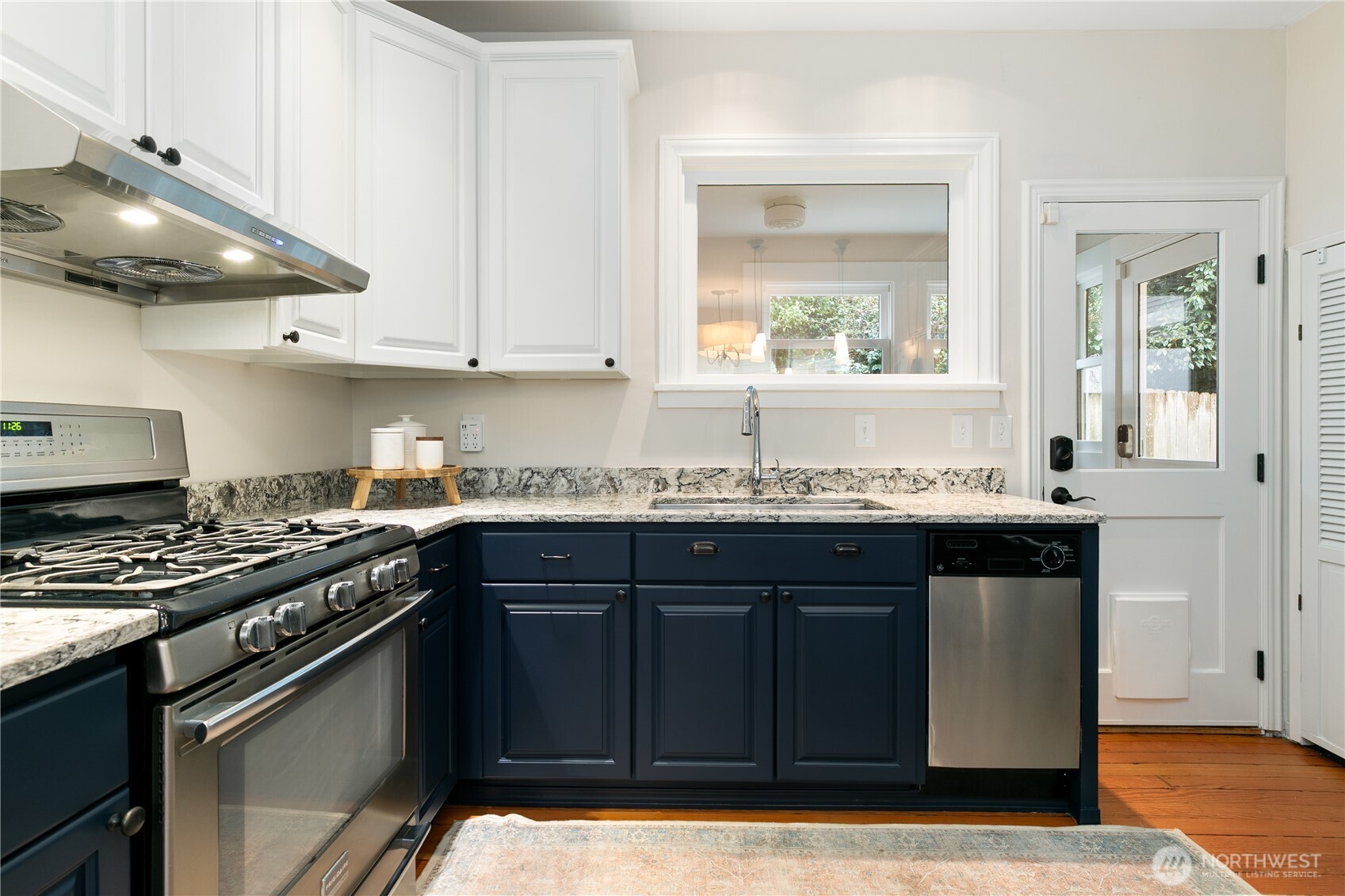 Beautifully remodeled designer kitchen boasts abundant counter space, a gas range, and high-end stainless steel appliances.