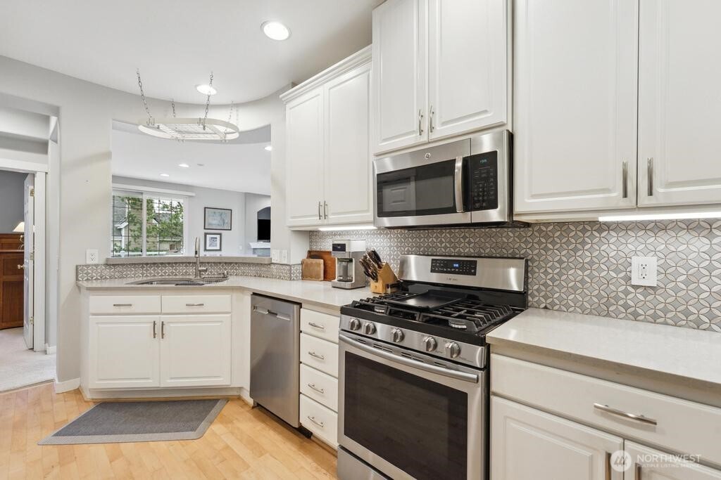 Chefs dream in this beautiful kitchen with lots of counter space and storage and custom back splash