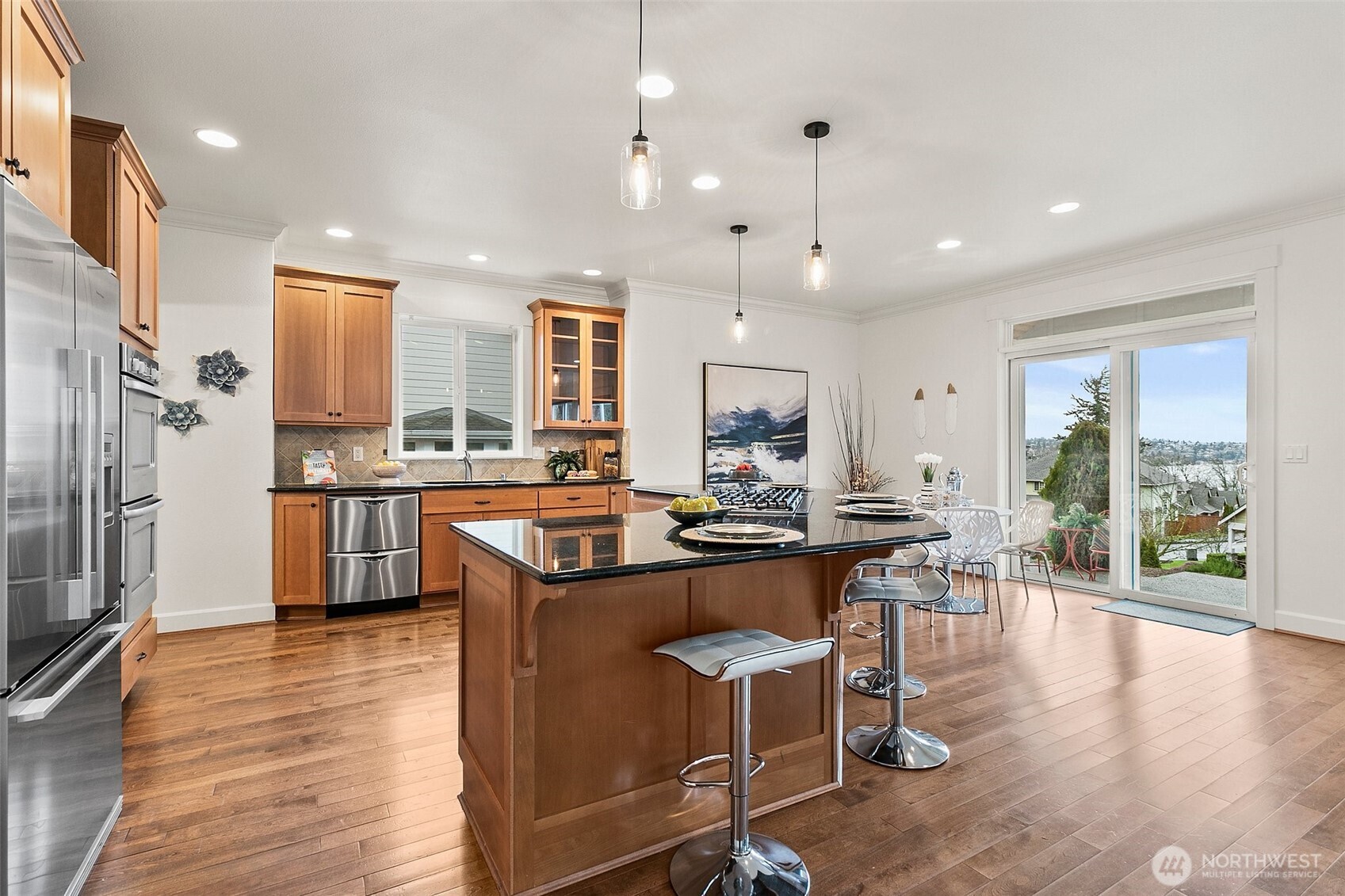 Very spacious kitchen with open floor plan to the dining nook and family room. Out the back slider you have views of Lake Washington and the Olympic Mountains.