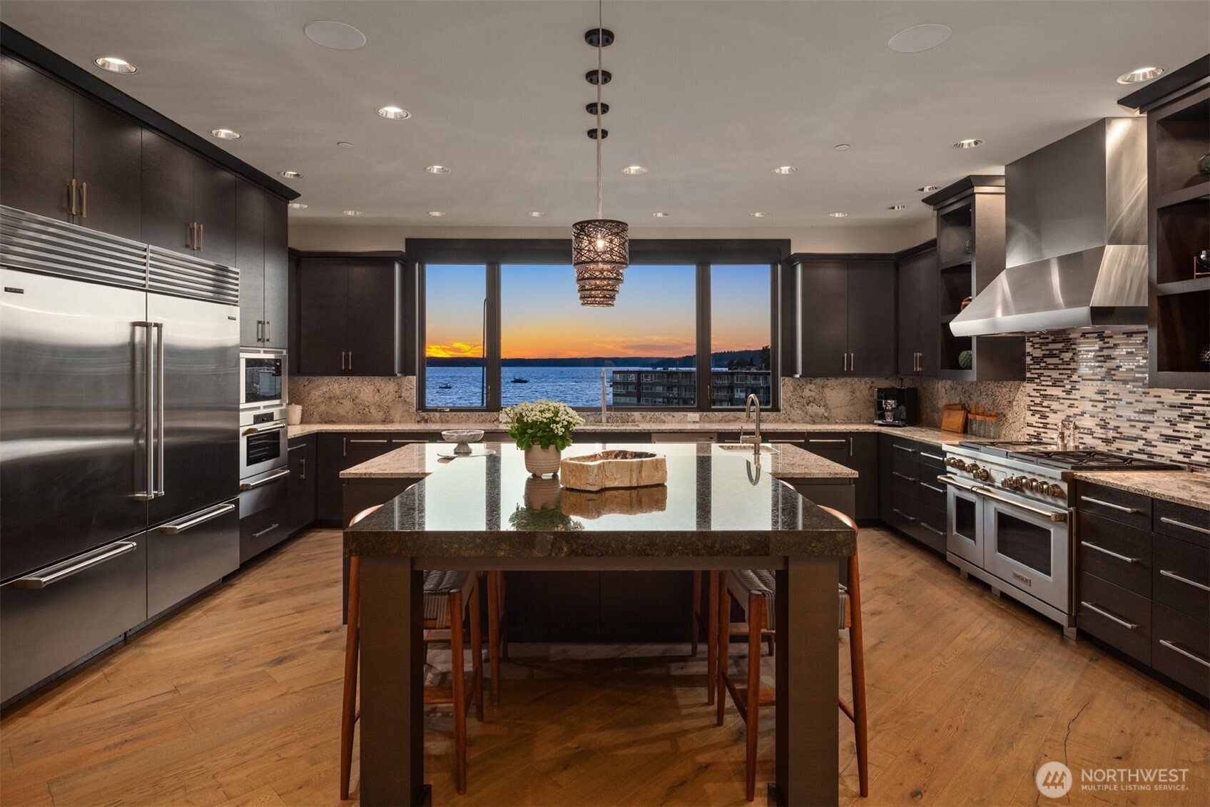 The spacious covered patio extends the living area seamlessly connecting through a stunning four-panel stacking sliding glass door.