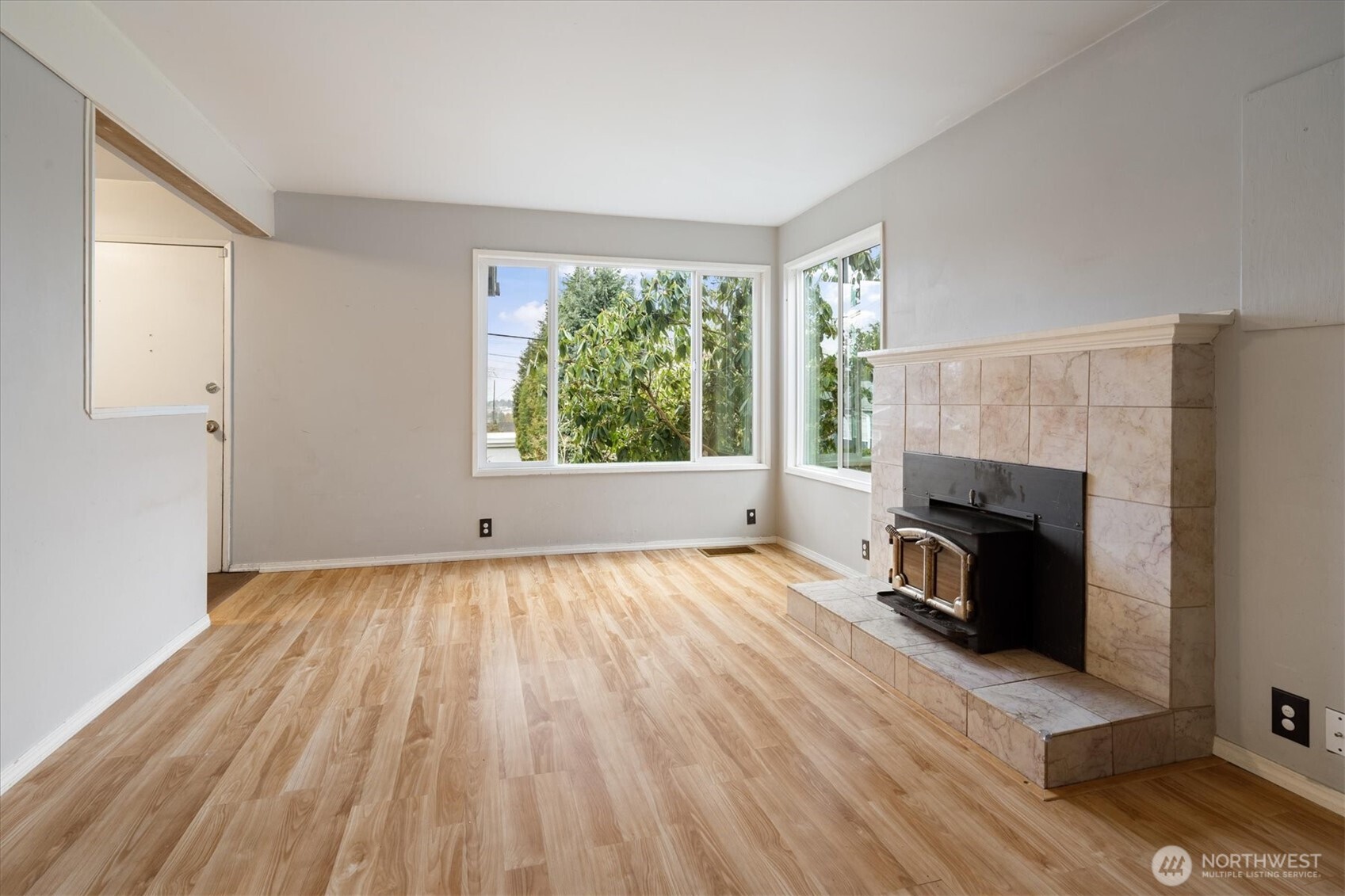 Living room with wood-burning fireplace insert.