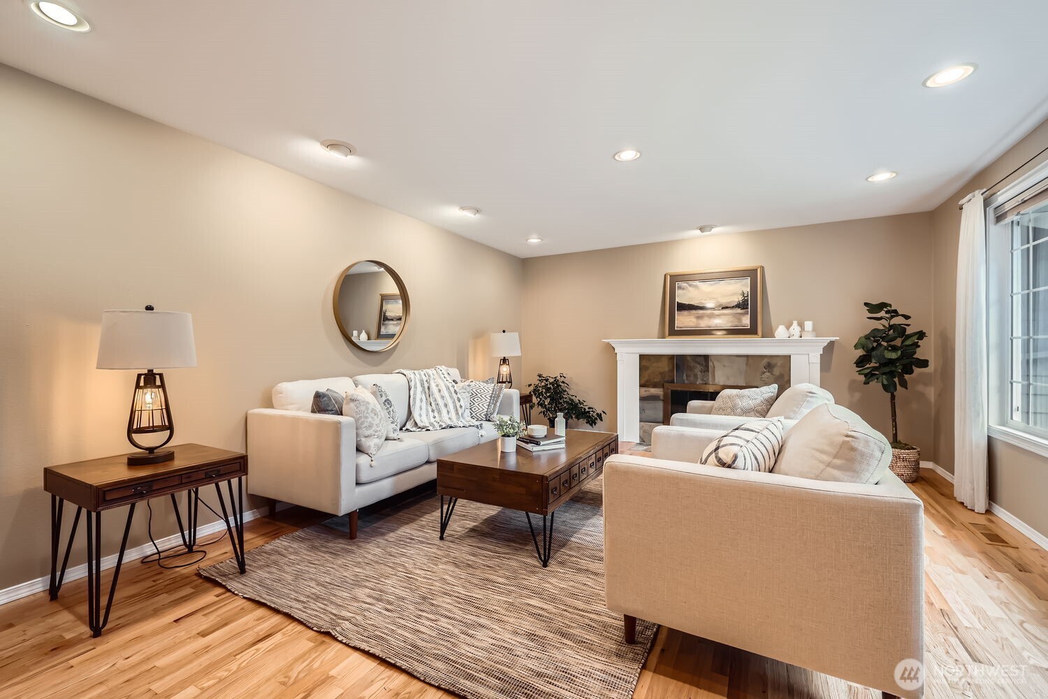 Wood burning fireplace, beautifully refinished hardwoods and warm paint color make this an inviting living room.