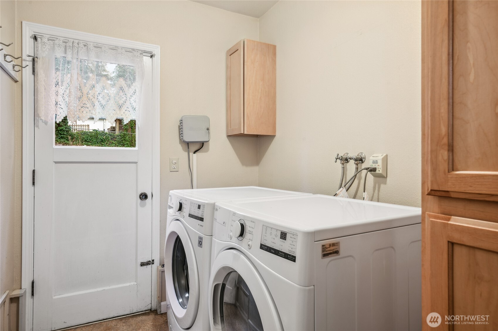 utility room with door to back yard