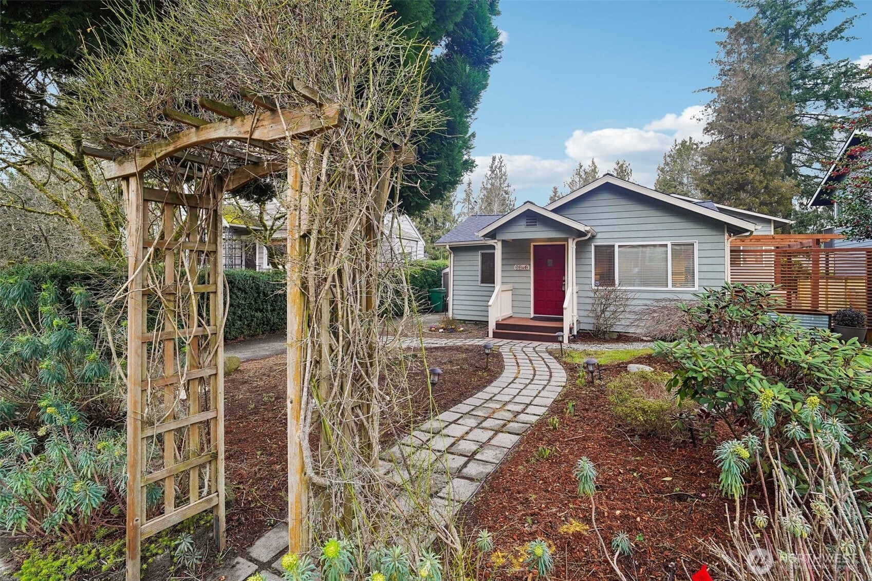 This beautifully reimagined home sits on a large, level lot with mature landscaping in the front and back. Just imagine this trellis in full bloom!