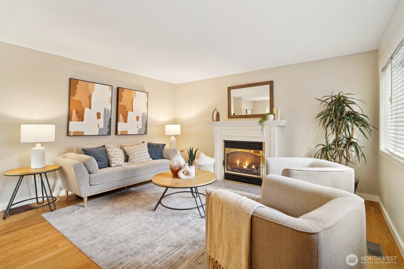 Hardwood floors sparkle with great sunlight pouring in through abundant windows, and the fireplace creates cozy ambiance on chilly winter evenings.