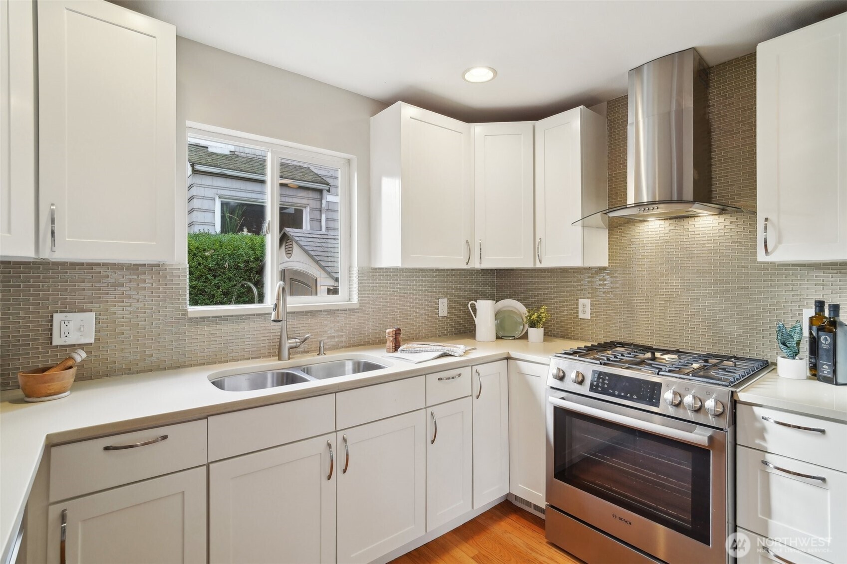 Outfitted with freshly painted cabinets, stainless steel appliances and ample work/storage space, this kitchen is the stuff of dreams!