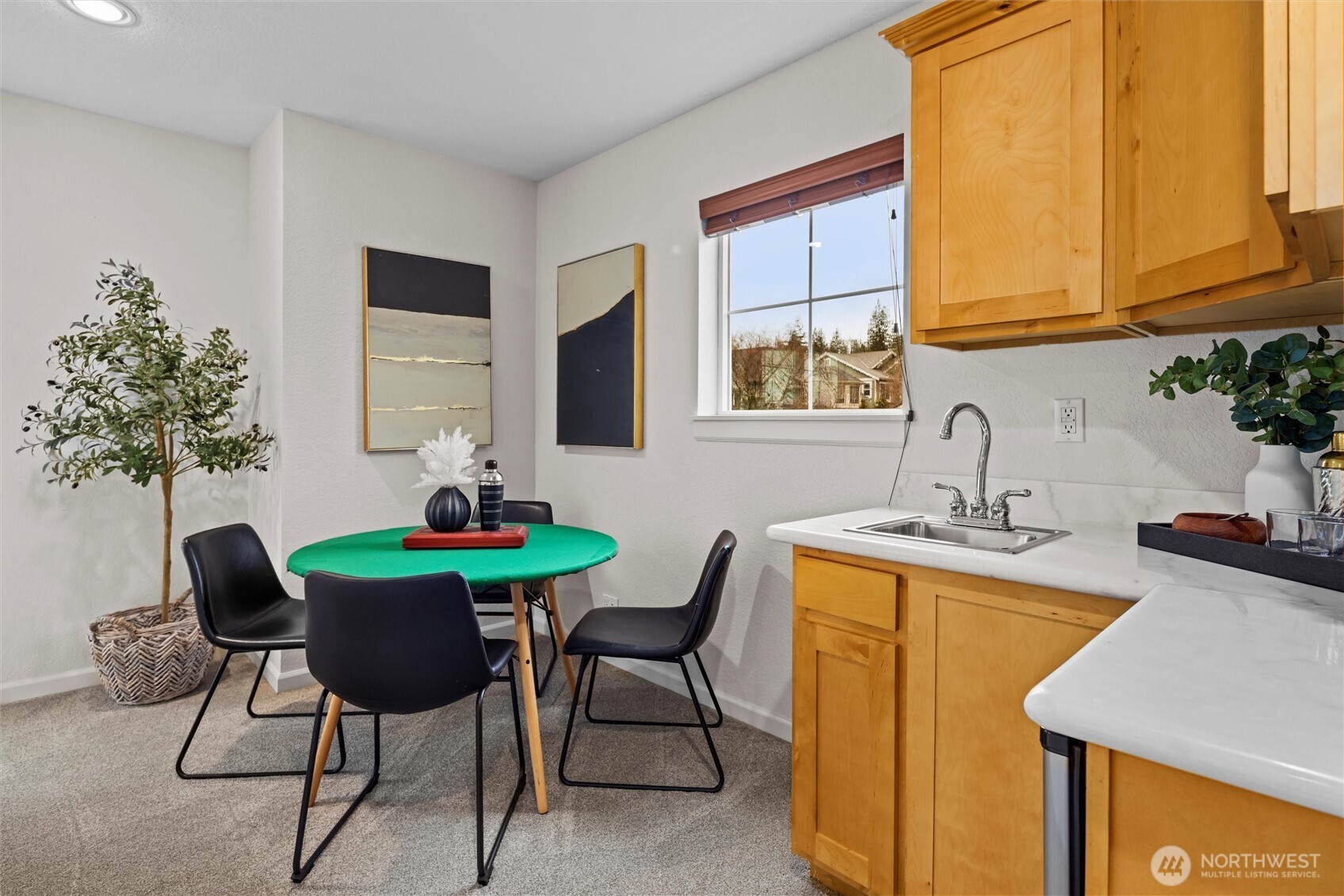 Kitchenette space with sink and mini fridge.