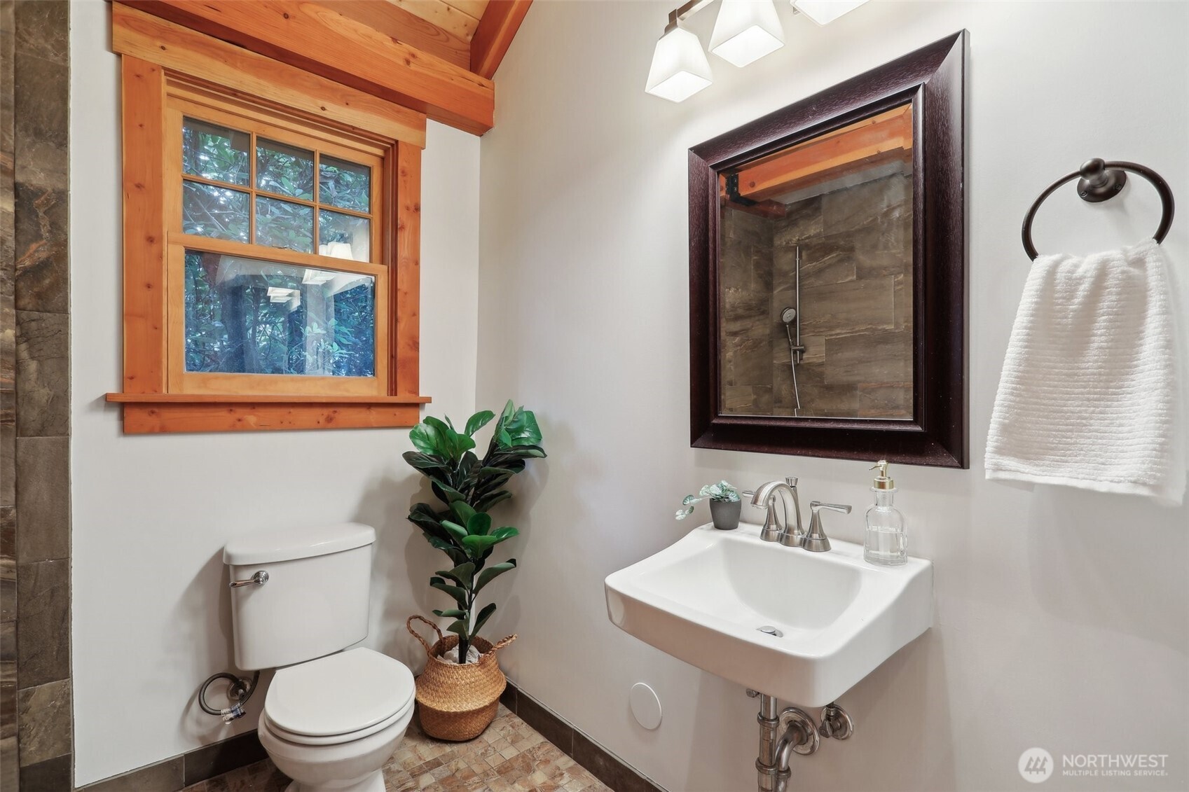 Three quarter bathroom with custom tiling.