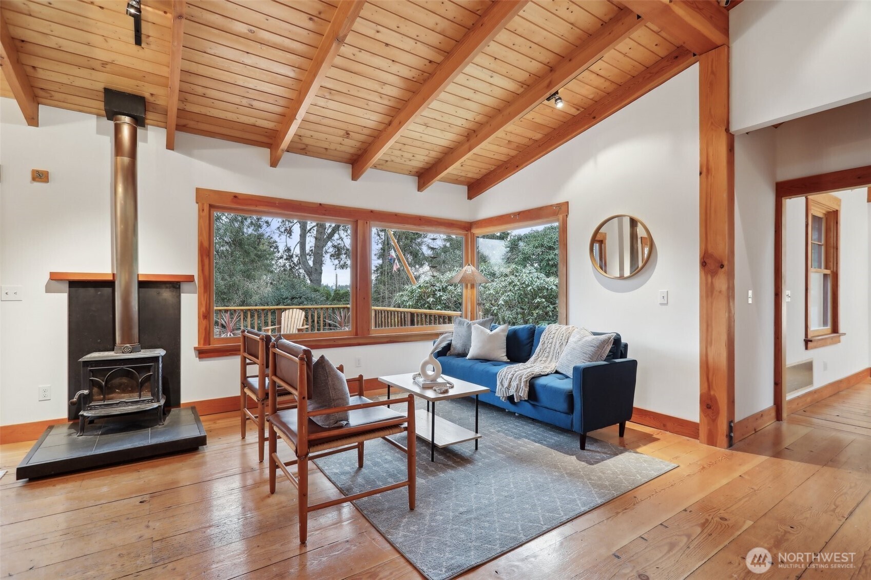 Cozy living space ideal for relaxing or entertaining featuring a classic woodstove.